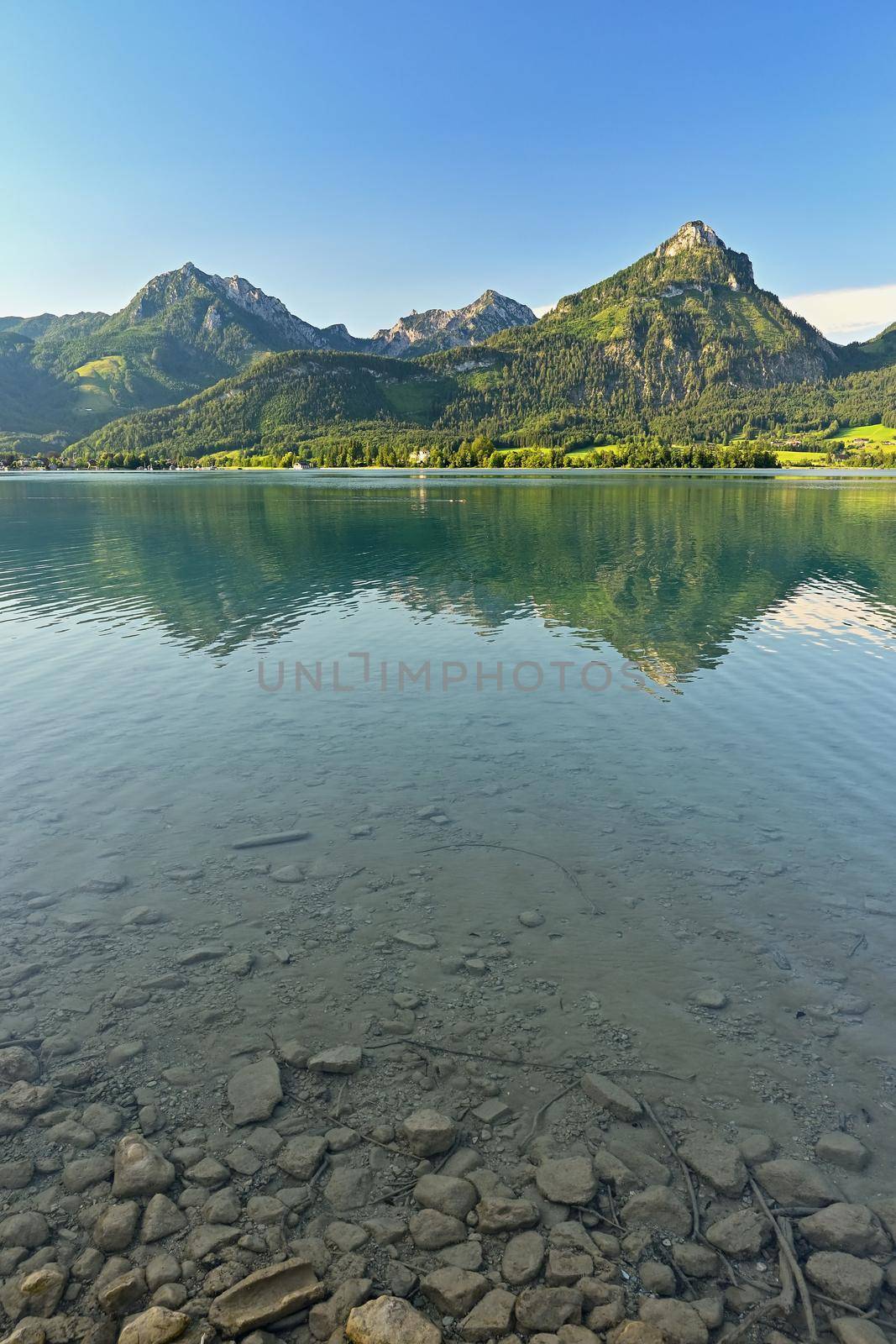 Beautiful landscape with lake and mountains in summer. Natural colorful background. Wolfgangsee lake in the Austrian applause. by Montypeter