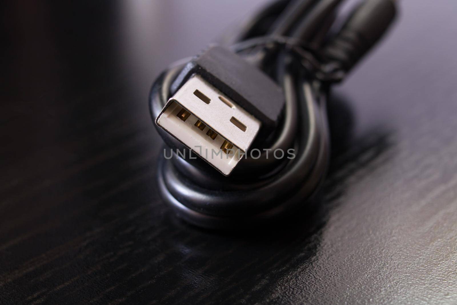 Twisted USB wire for telephone on a wooden background