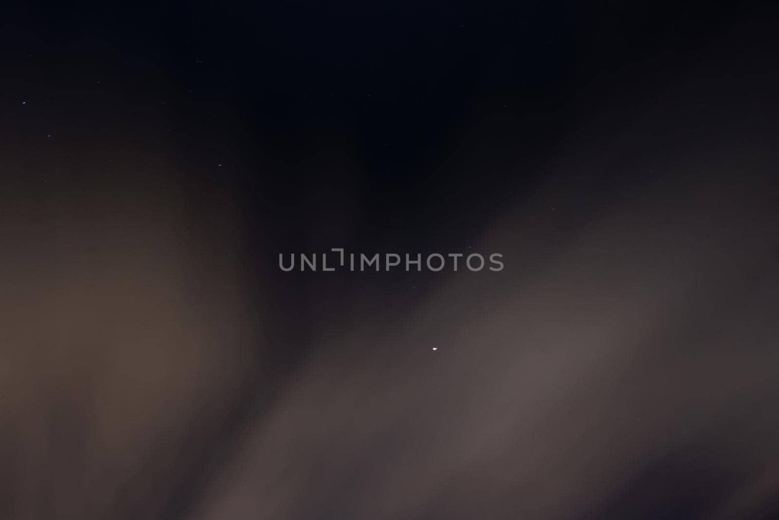 Night blue sky with stars and clouds, blurred background
