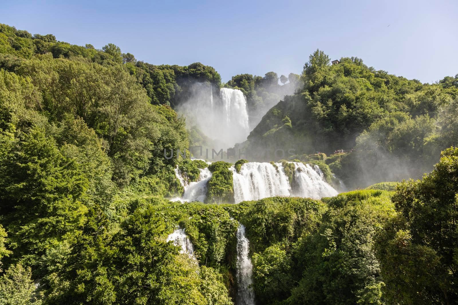 Marmore waterfall in Umbria region, Italy. Amazing cascade splashing into nature with trees and rocks.