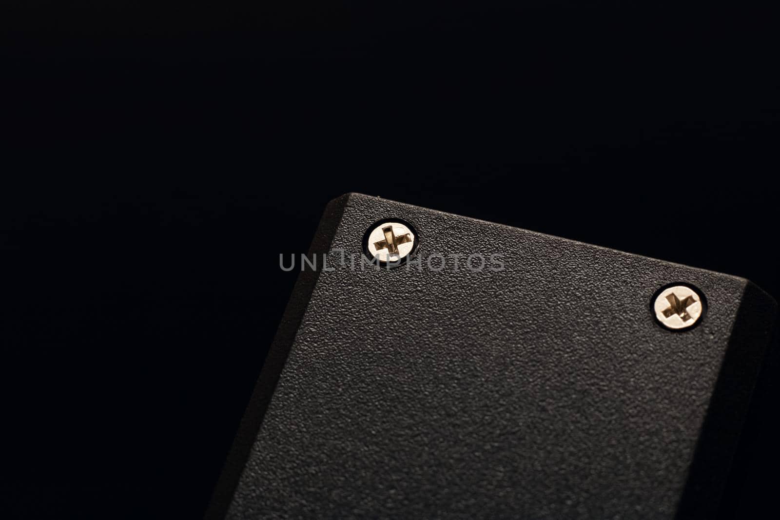 Locked nuts on a black plastic device close up
