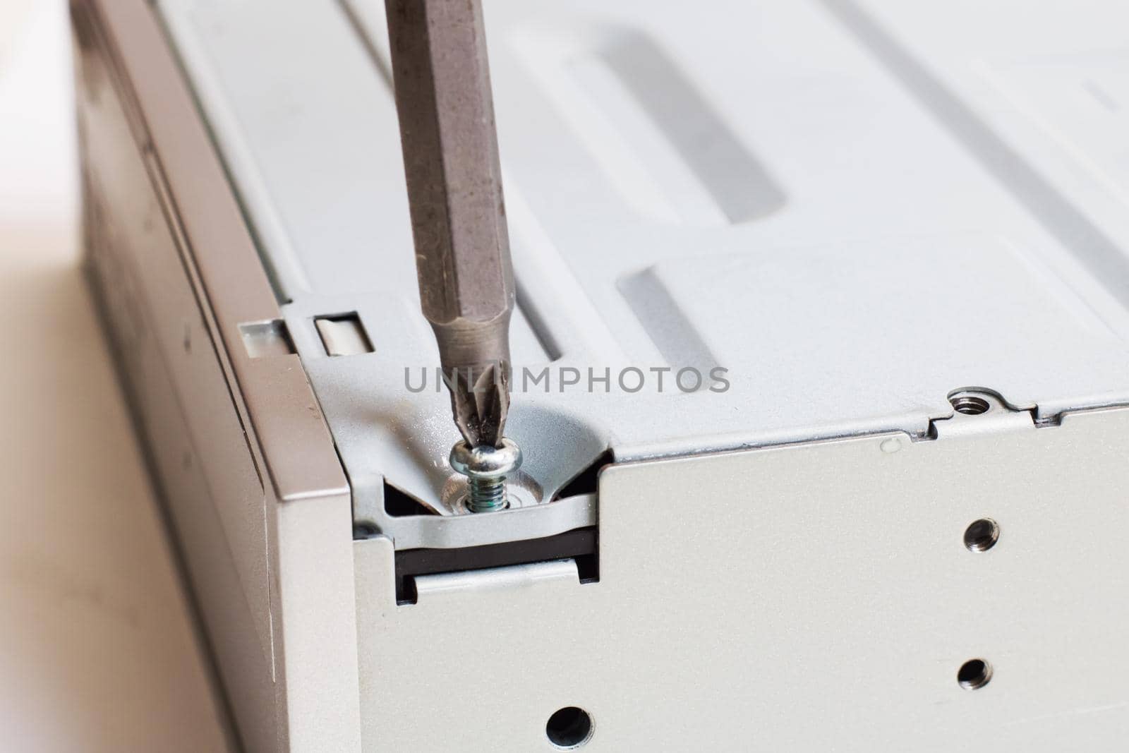 Disassembled computer disk drive on a white background