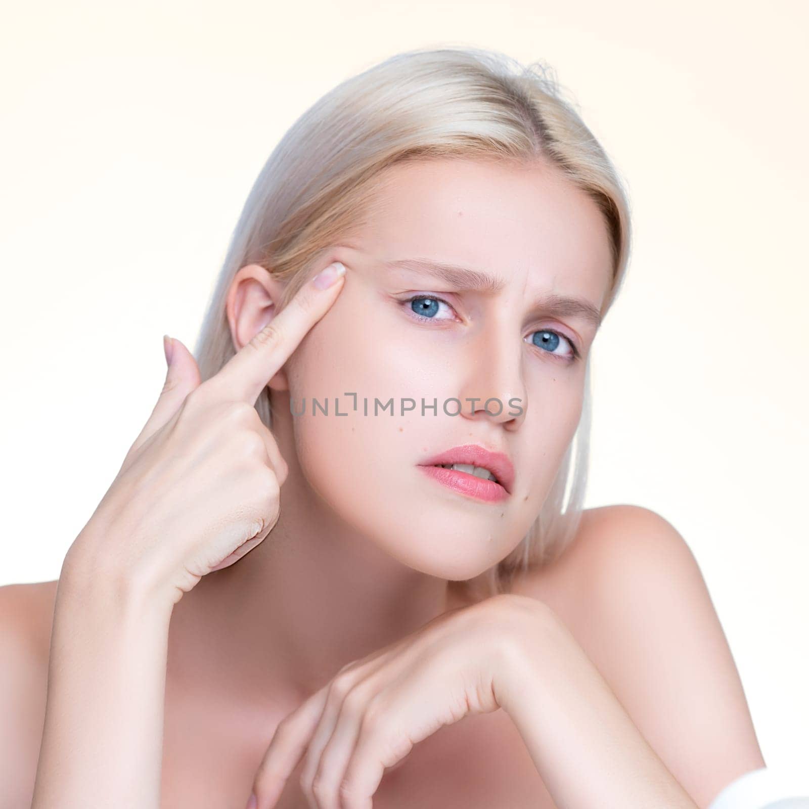 Acne problem troubling closeup personable worried woman with natural beauty skin checking her face squeezing pimple spots in isolated background. Copyspace for blemish skincare treatment problem.