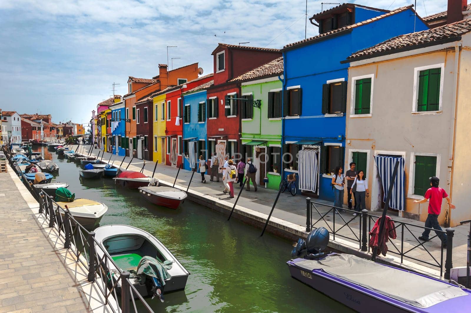 Venice, Italy - 06/09/2009 - Tourists visiting Burano. The island of the Venetian lagoon famous for its brightly colored houses