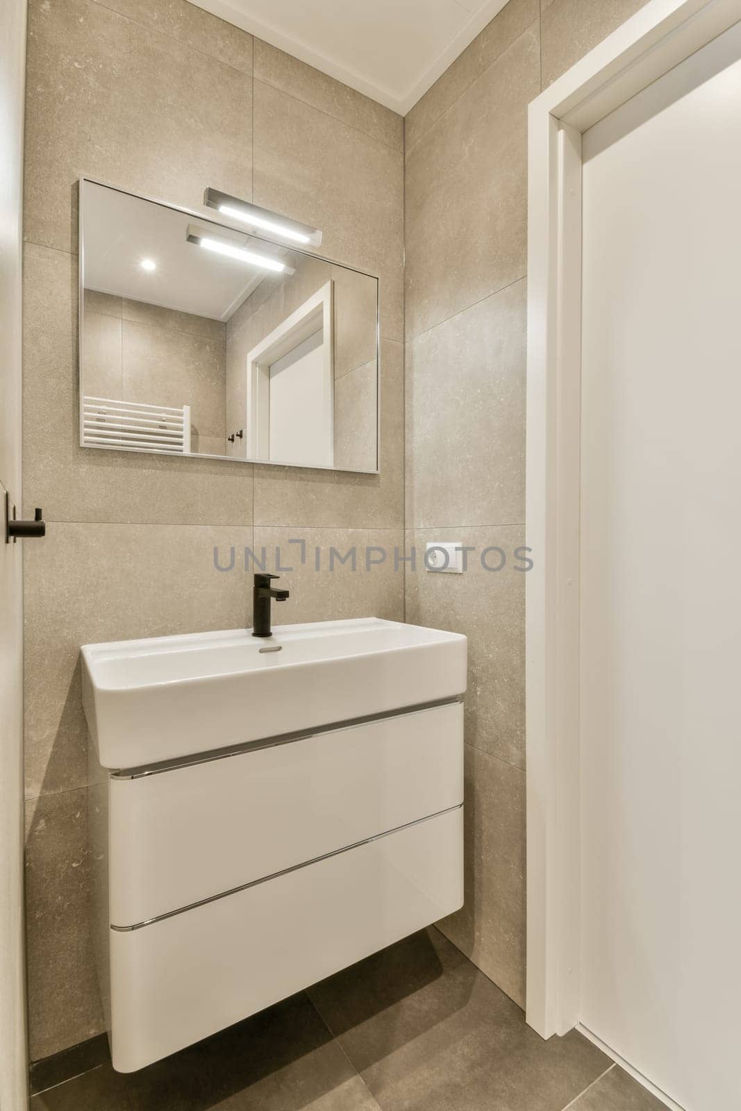 a small bathroom with a sink and a mirror by casamedia