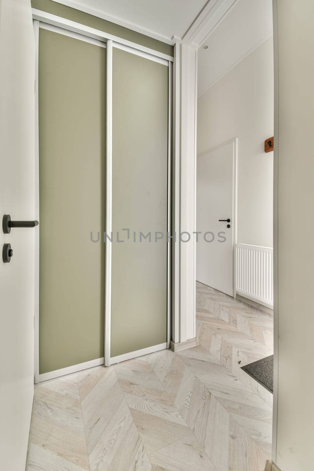 an empty room with two doors and one door open to the other room, which is very light green in color