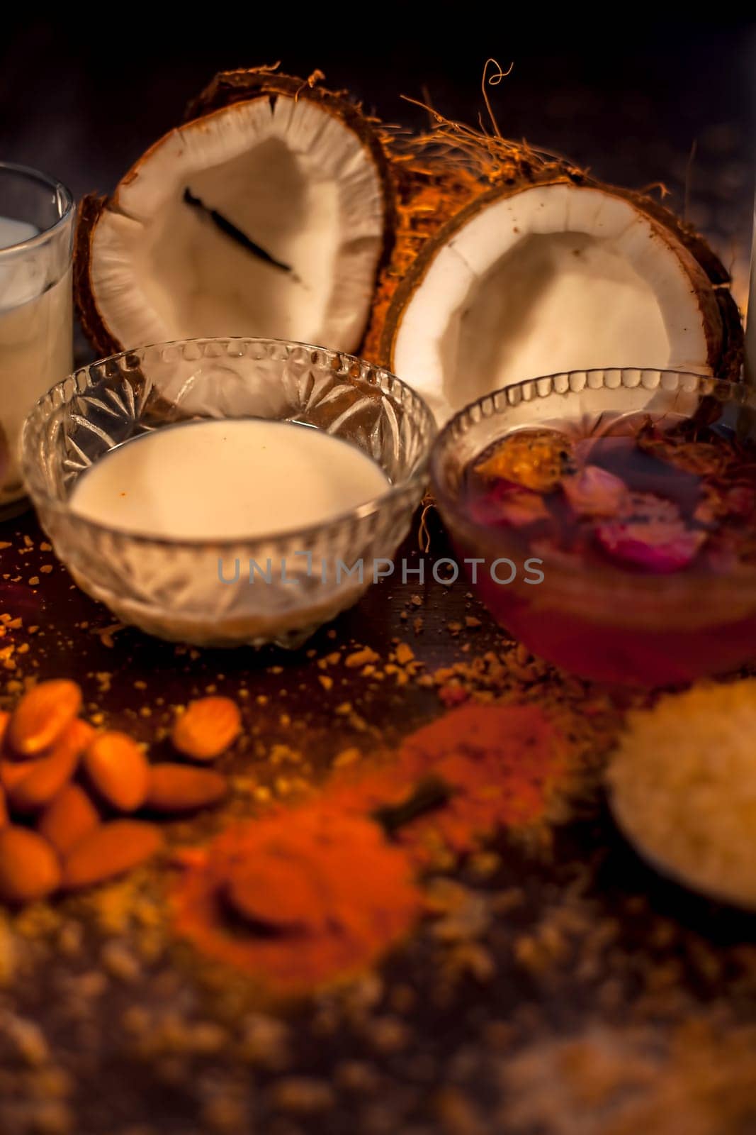 Complete face mask of coconut, consisting of coconut milk, rose water, yogurt, buttermilk, oatmeal, almonds, lime juice, turmeric, rice flour, honey, olive oil, and sandalwood powder. Vertical shot. by mirzamlk
