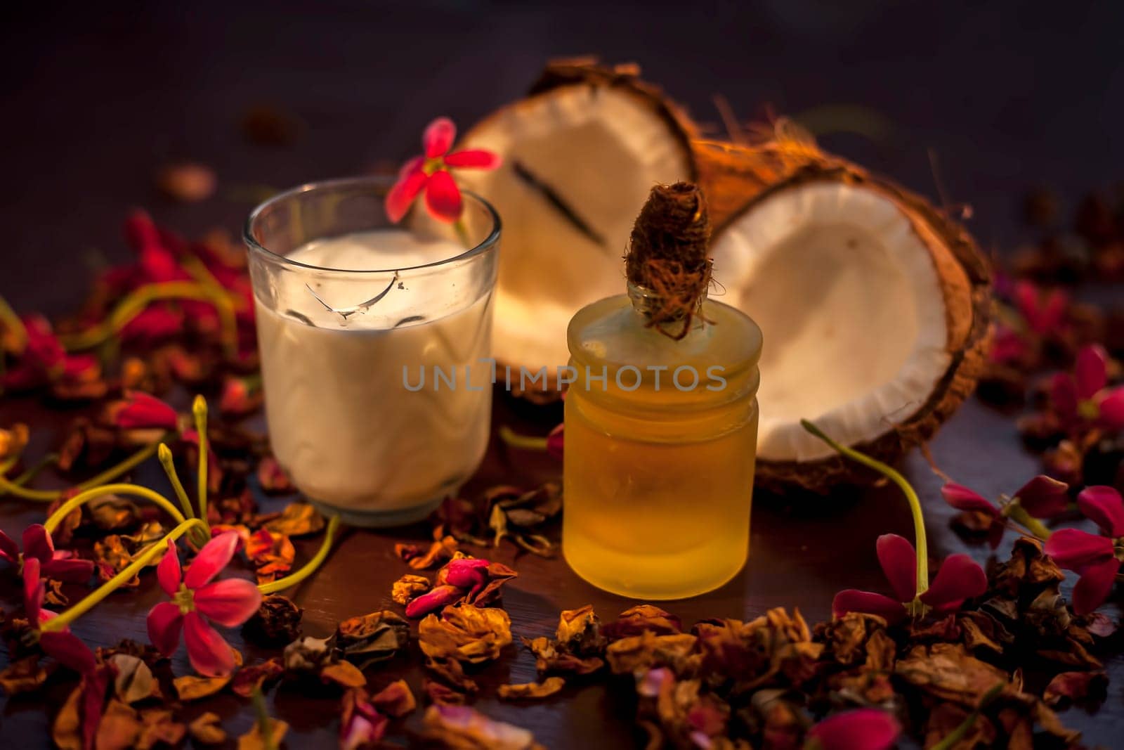 Coconut face mask on the brown colored surface consisting of some coconut milk and olive oil when applied penetrates the skin and exfoliates deeply. Face mask for protection against skin damage. by mirzamlk