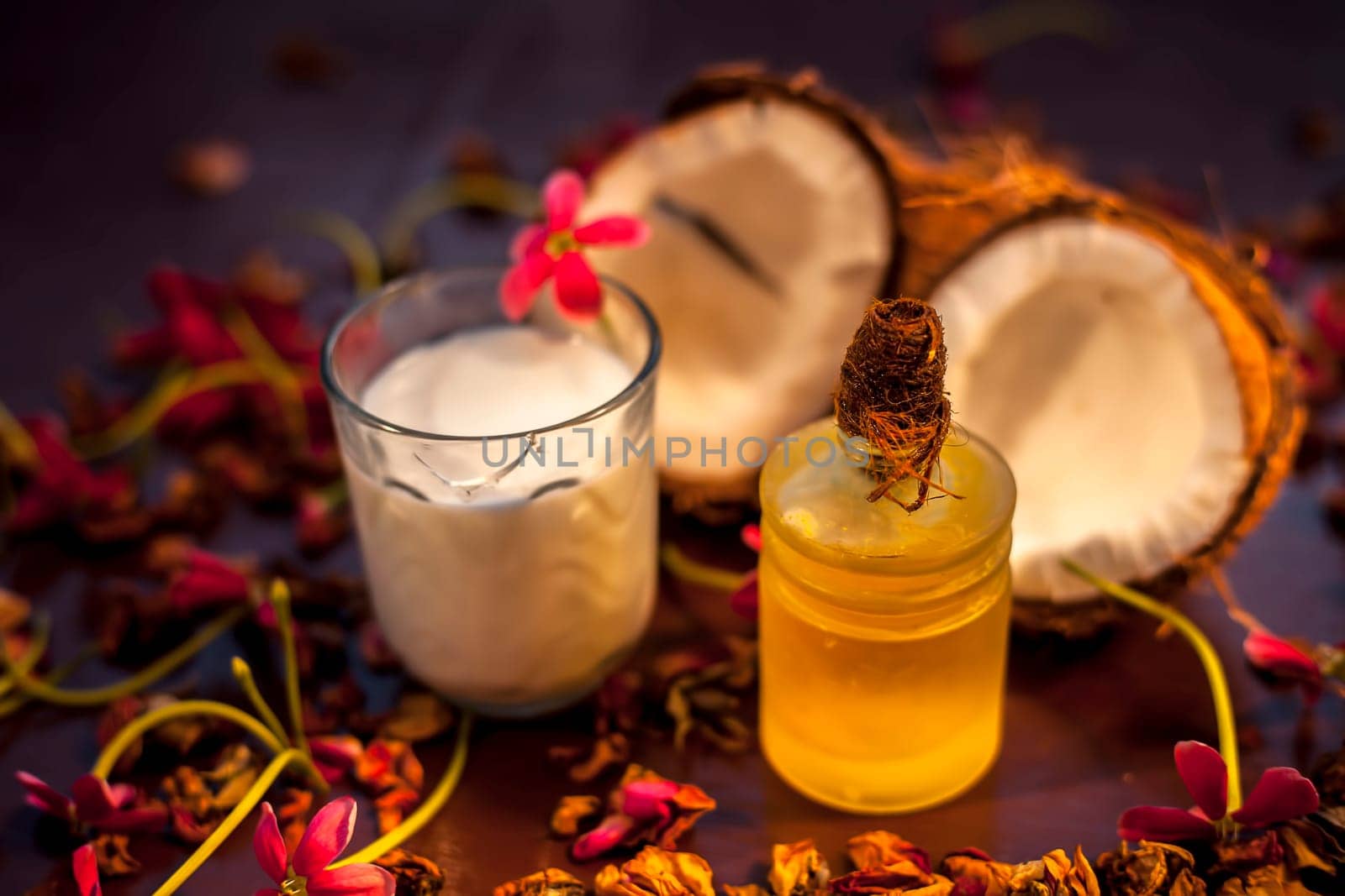 Coconut face mask on the brown colored surface consisting of some coconut milk and olive oil when applied penetrates the skin and exfoliates deeply. Face mask for protection against skin damage. by mirzamlk