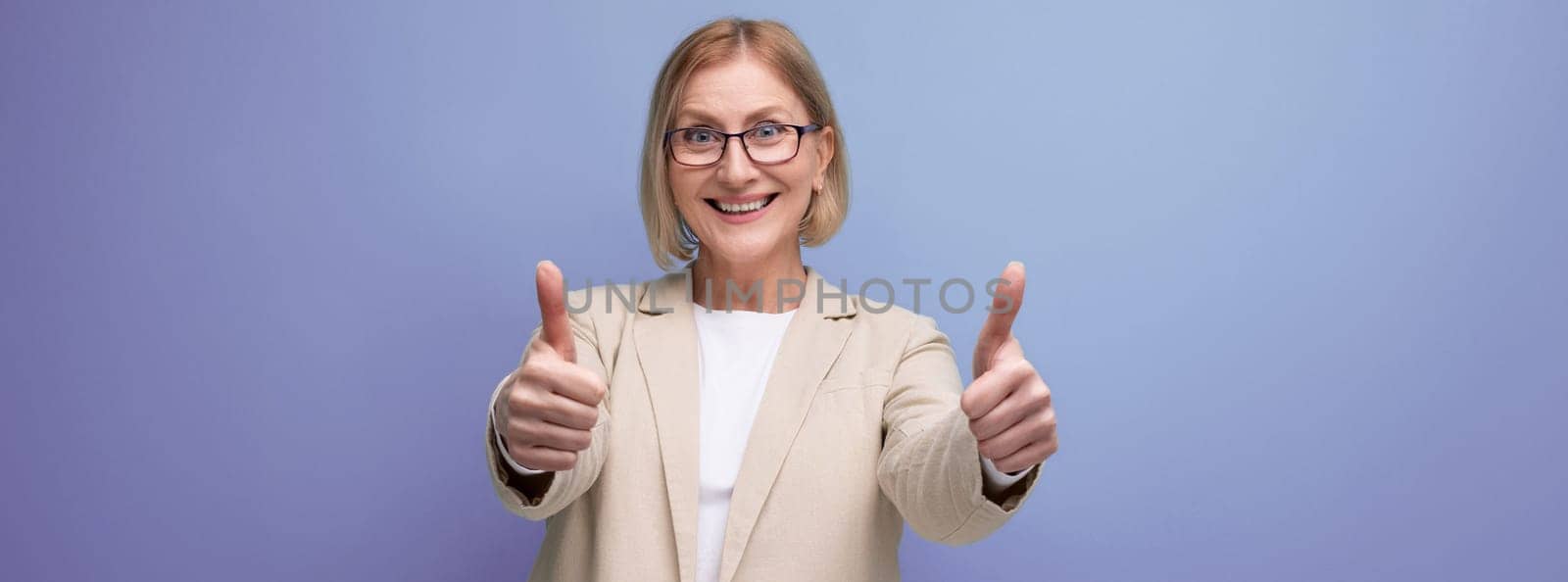 50s business woman in a stylish jacket on a bright studio background with copy space by TRMK