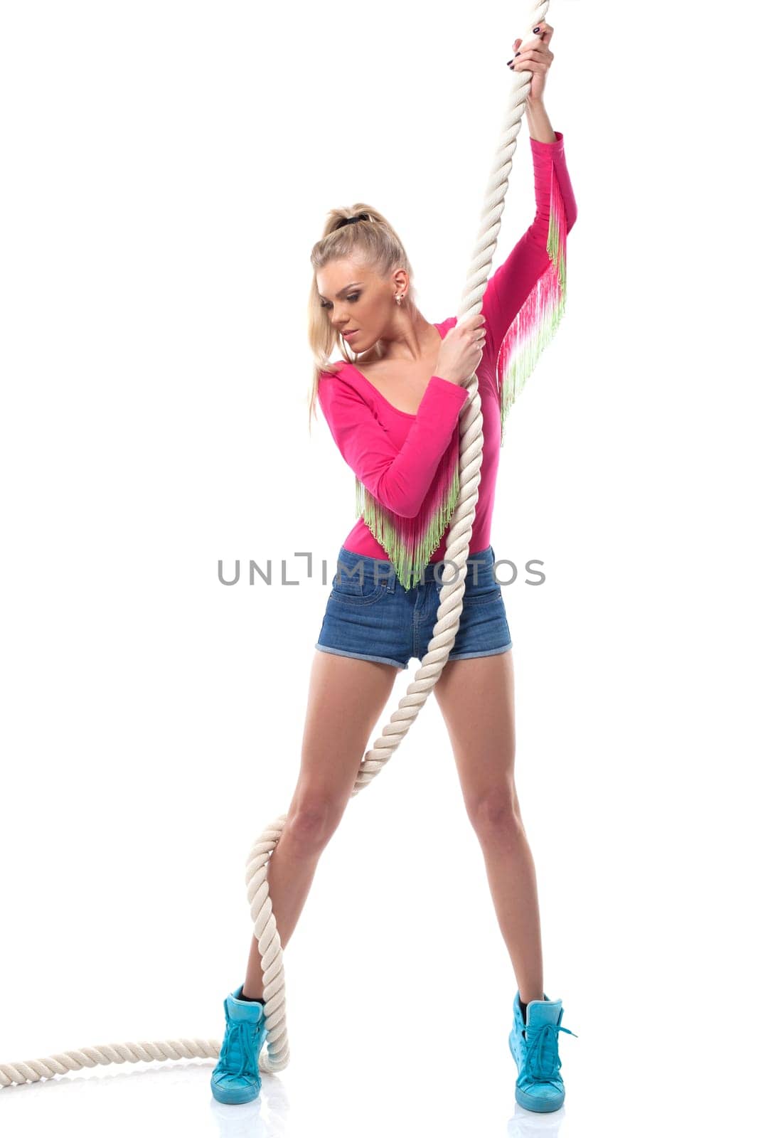 Young athletic girl posing with rope, isolated on white