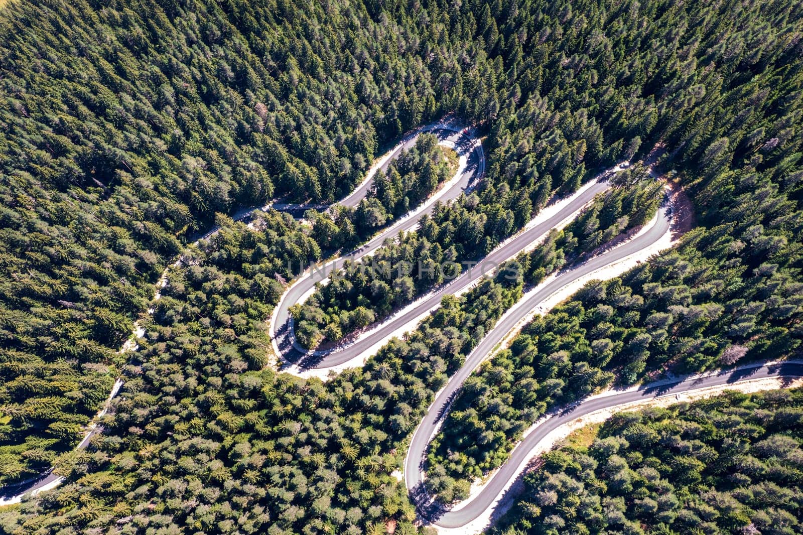 Aerial view from drone of curves of mountain road. Transportation and infrastructure concept