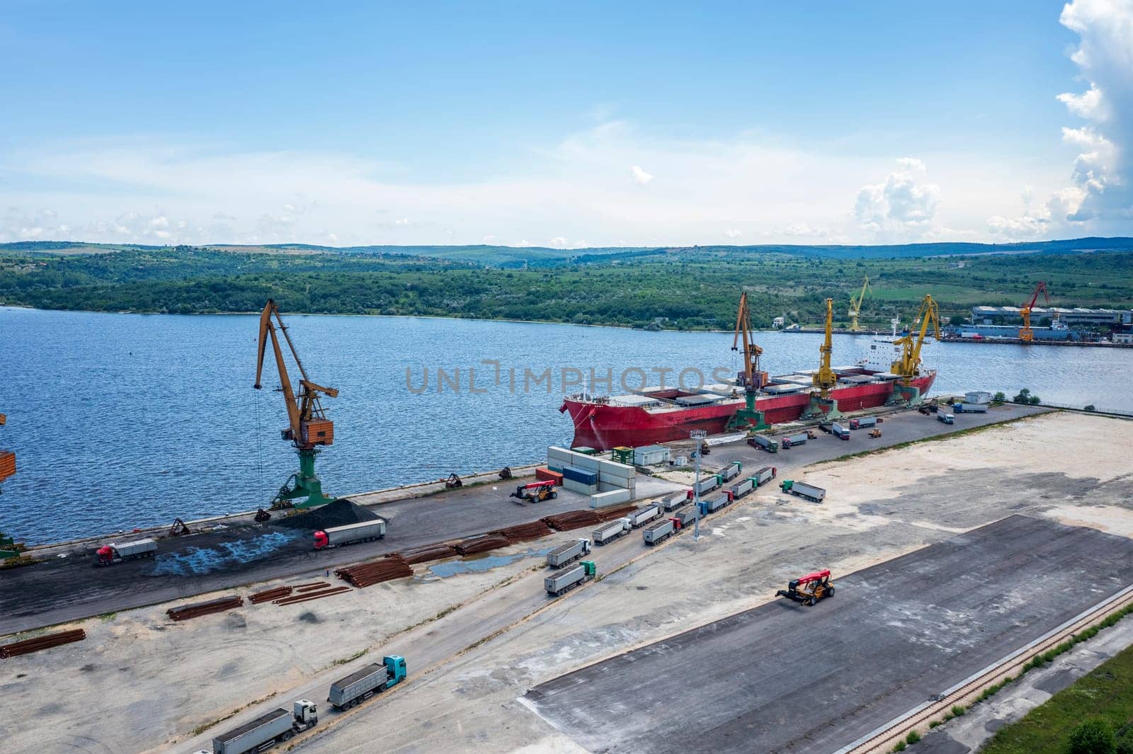 Aerial view from a drone of an industrial port loading the cargo ship.