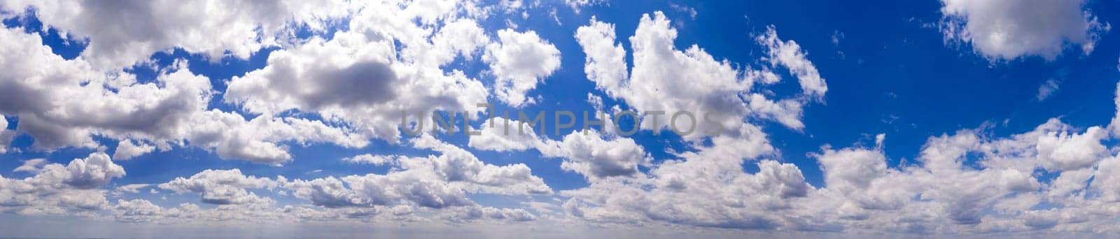 Panoramic view of blue sky with clouds and sunlight