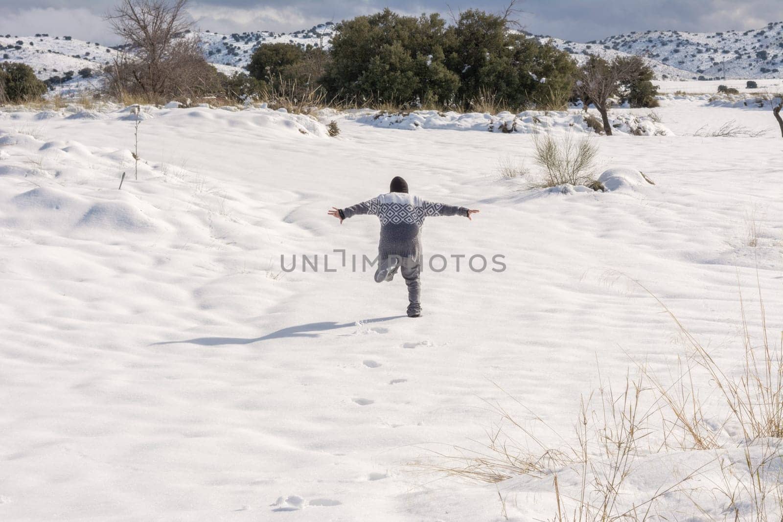 boy running and enjoying the snowy landscape,