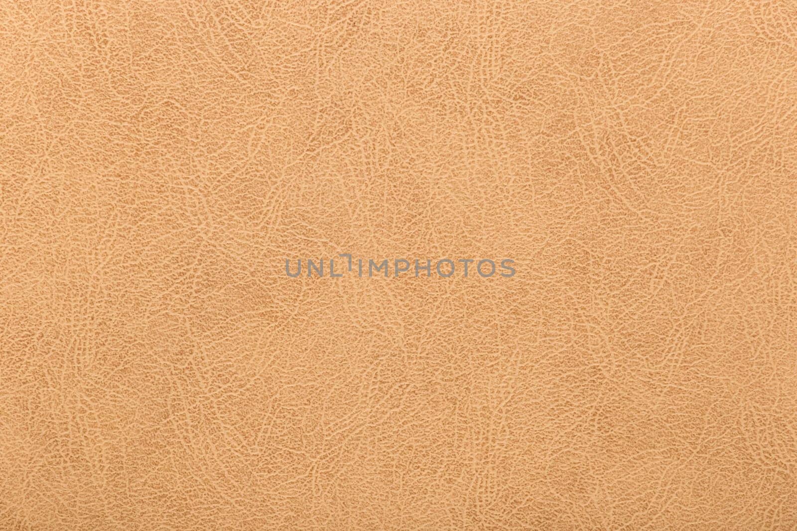 Light cracked skin surface retro texture material background warm color abstract leather pattern.