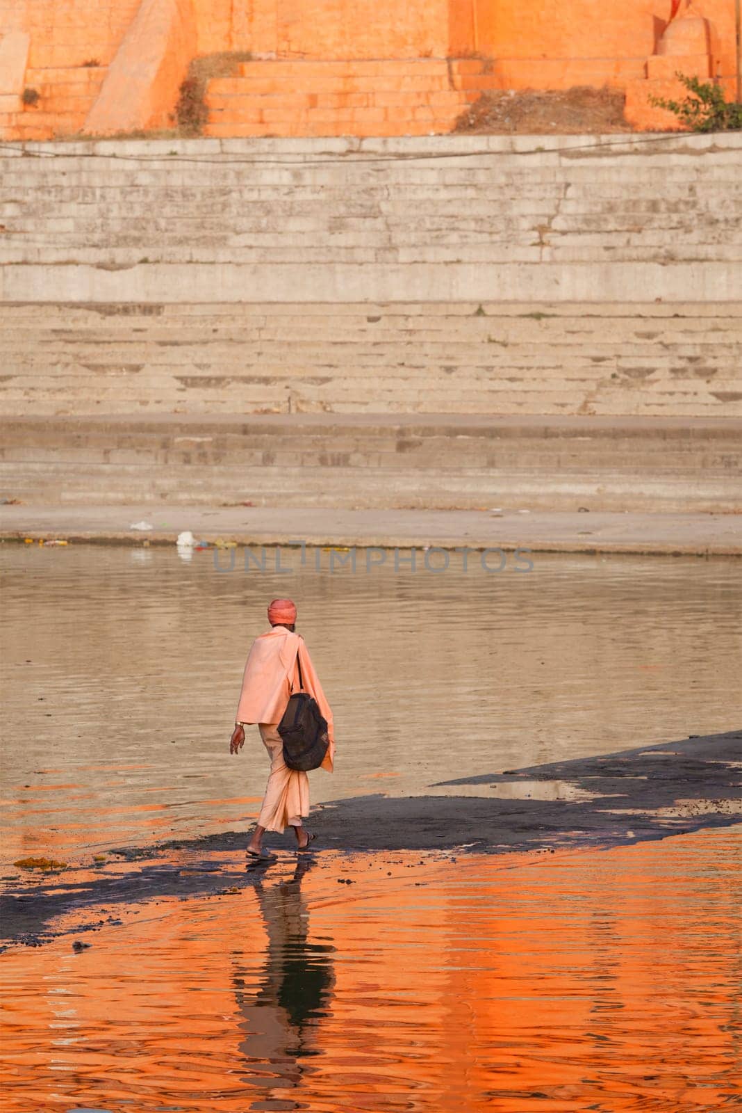 UJJAIN, INDIA - APRIL 25, 2011: Sadhu crossing holy Kshipra river. Shipra is one of the sacred rivers in Hinduism