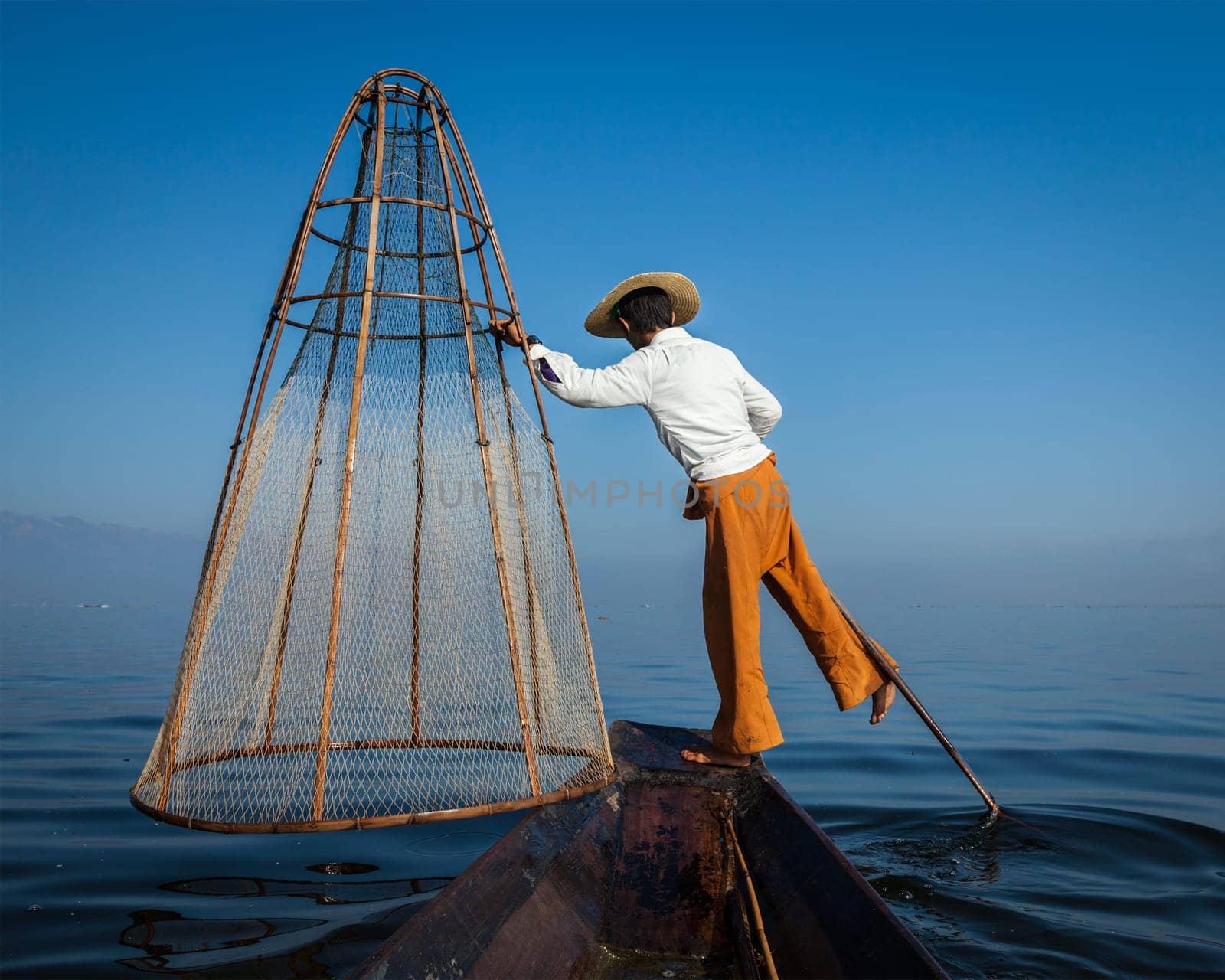 Traditional Burmese fisherman at Inle lak, Myanmar by dimol