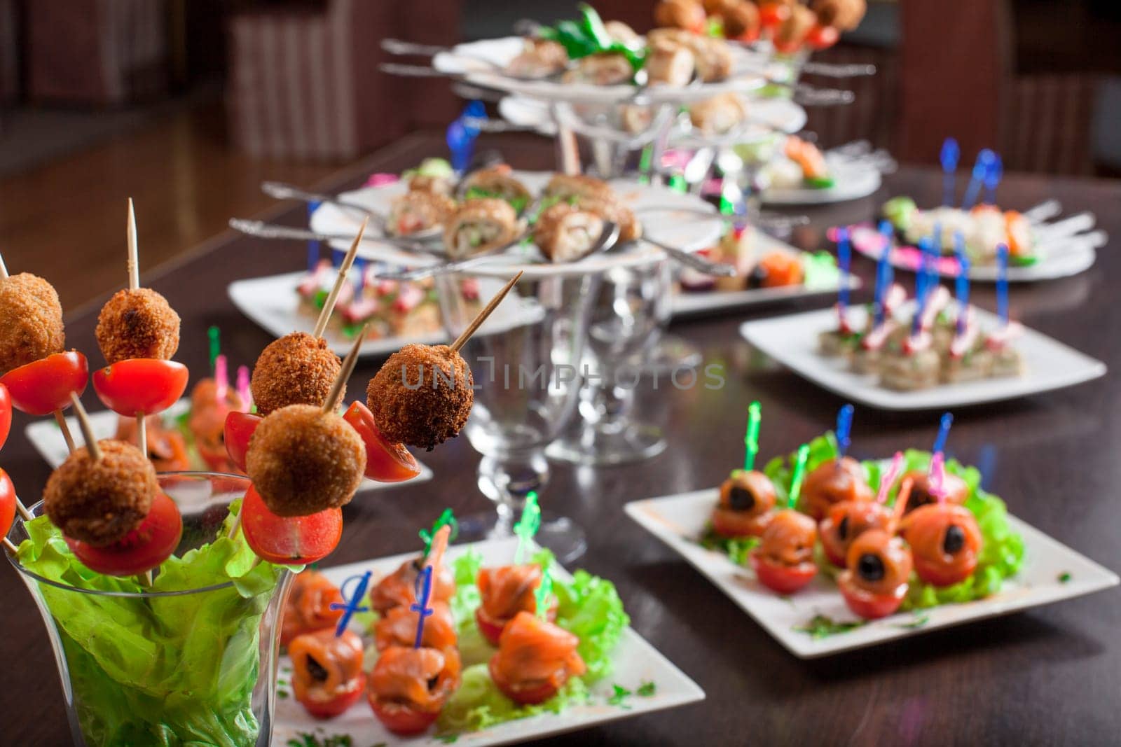 Banquet table covered with variety of snacks, close-up