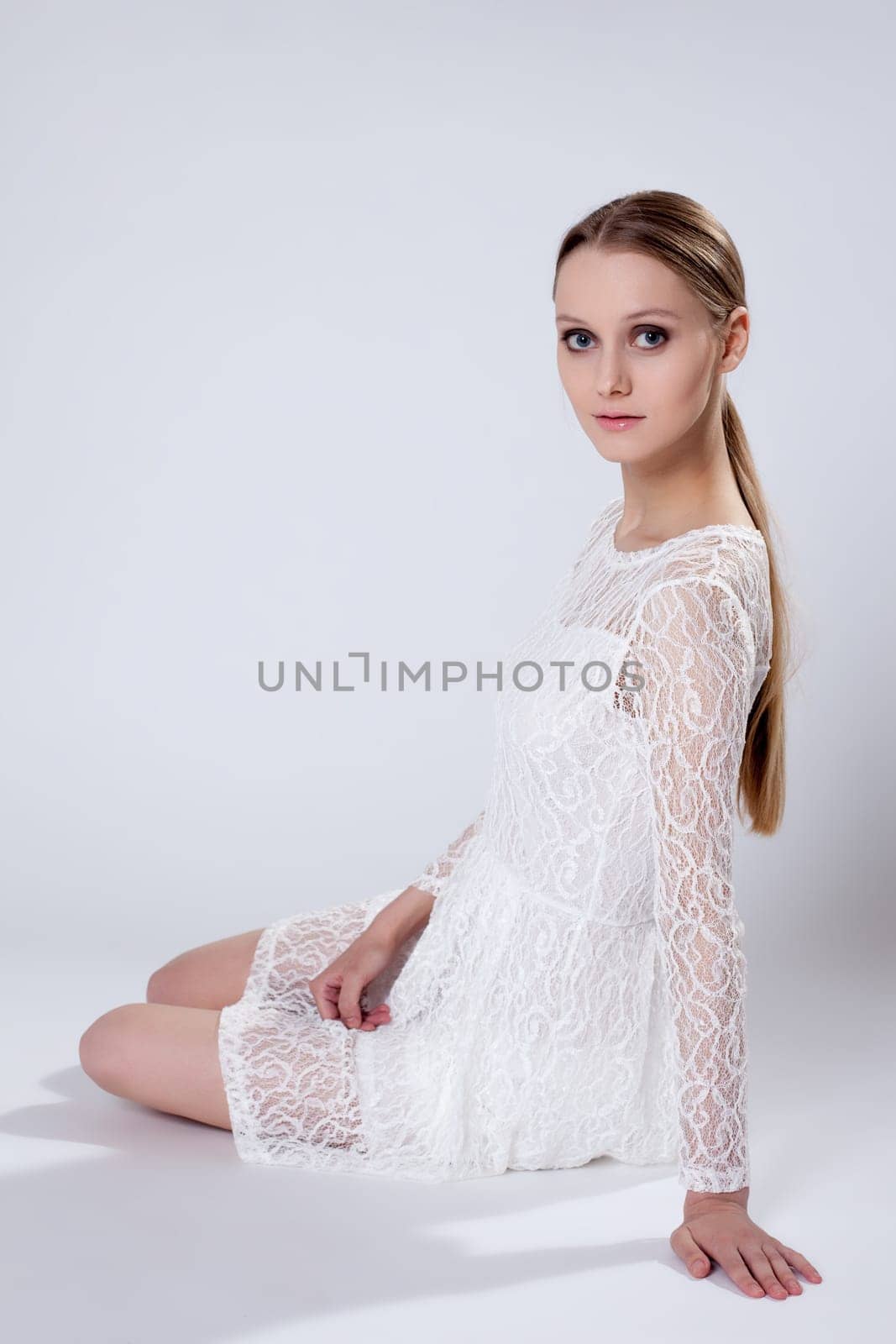 Romantic young girl posing in elegant dress by rivertime