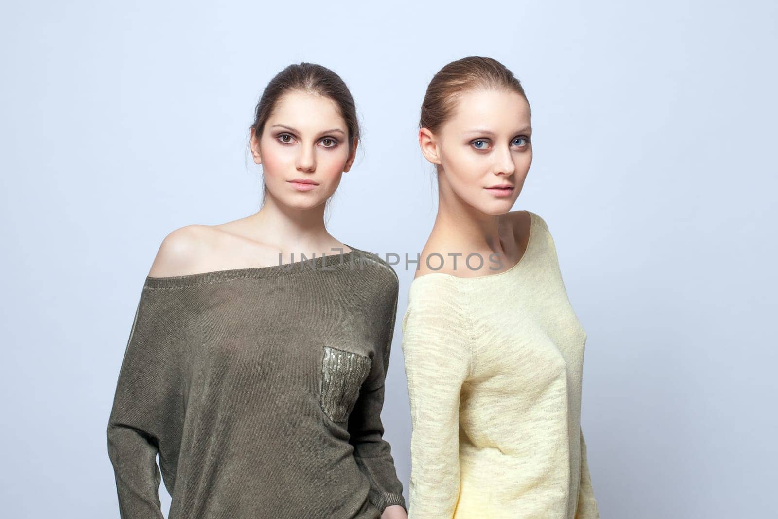 Image of two charming models posing in casual clothes