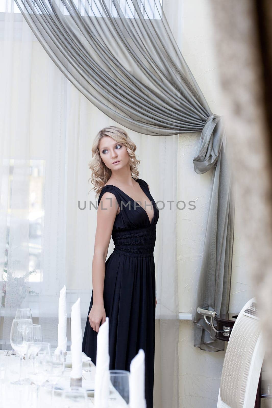 Luxury young woman posing in hotel's restaurant, close-up