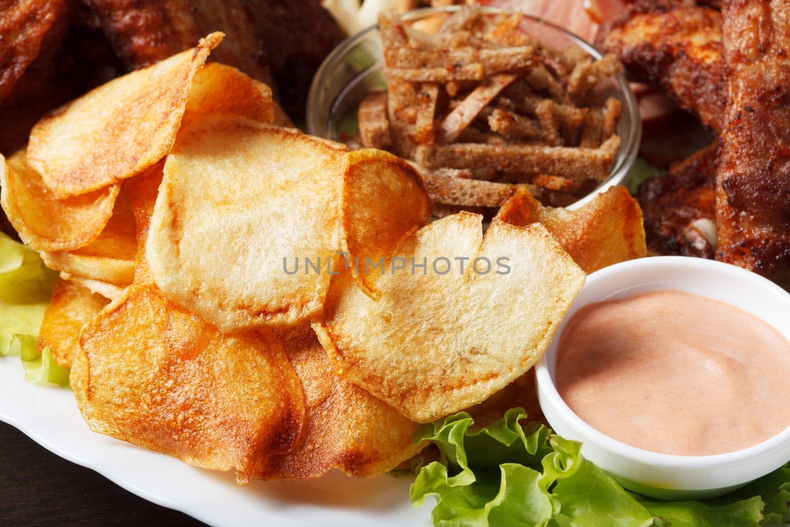 Delicious crunchy snacks with sauce, close-up