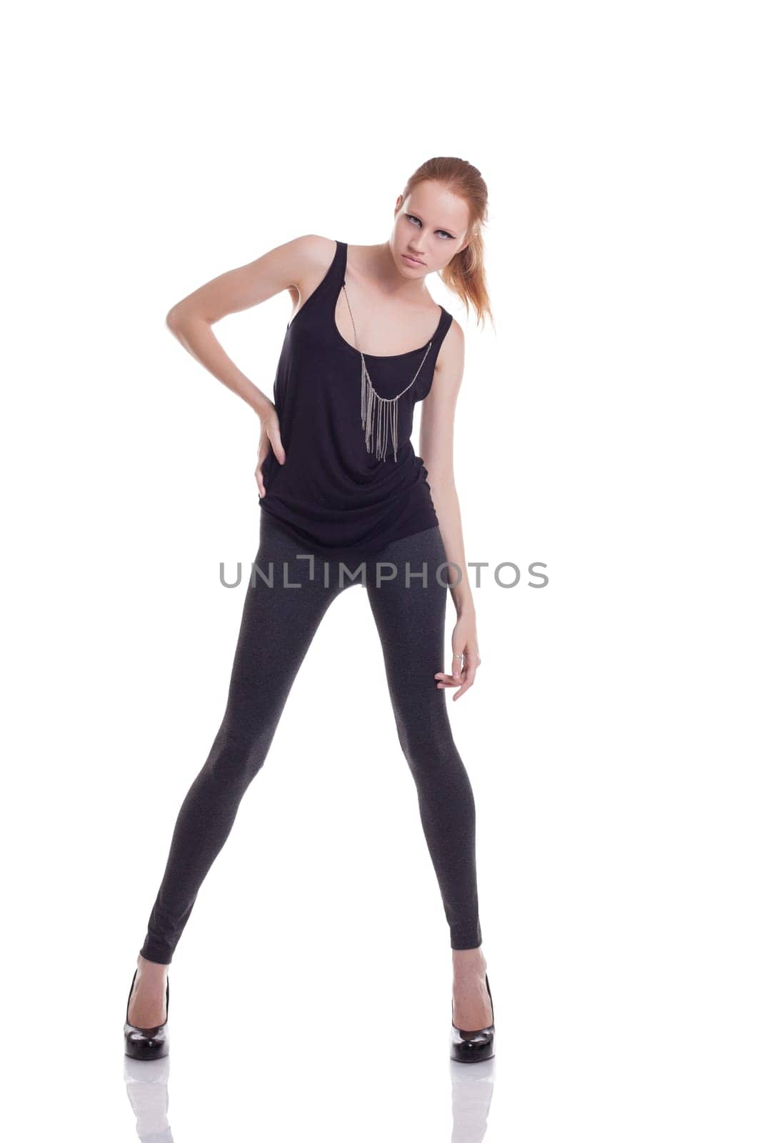 Slim fashionable woman posing looking at camera, isolated on white