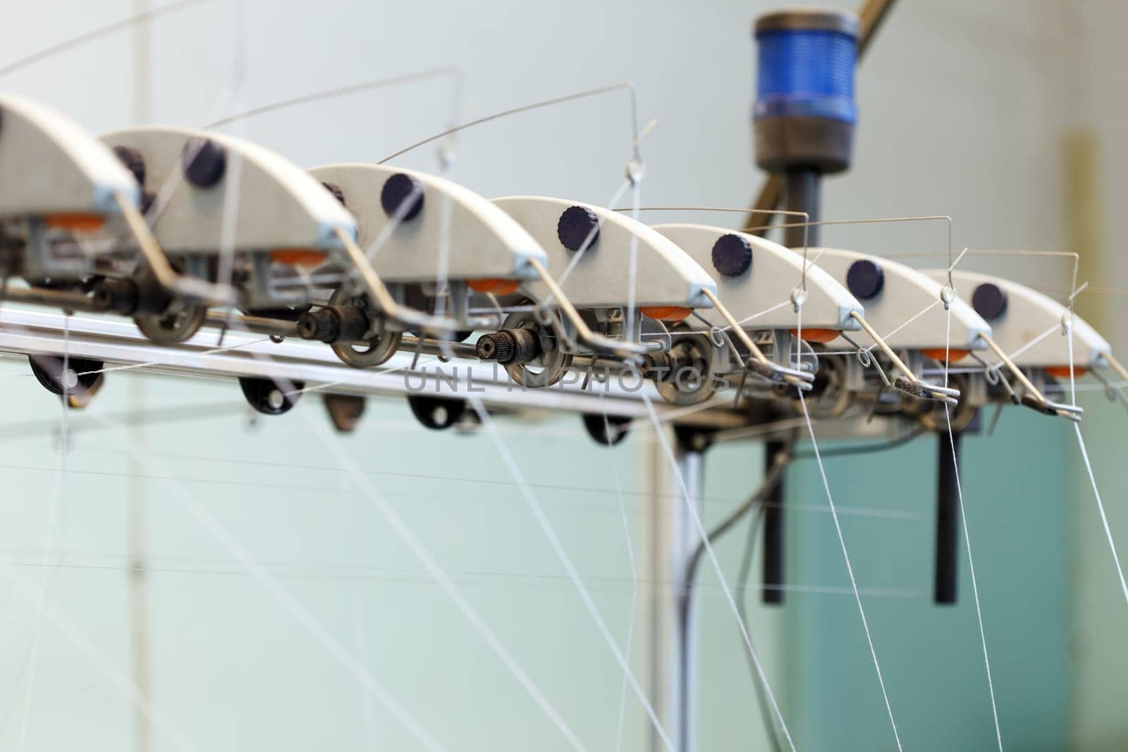 Image of threads on loom in weaving shop, close-up