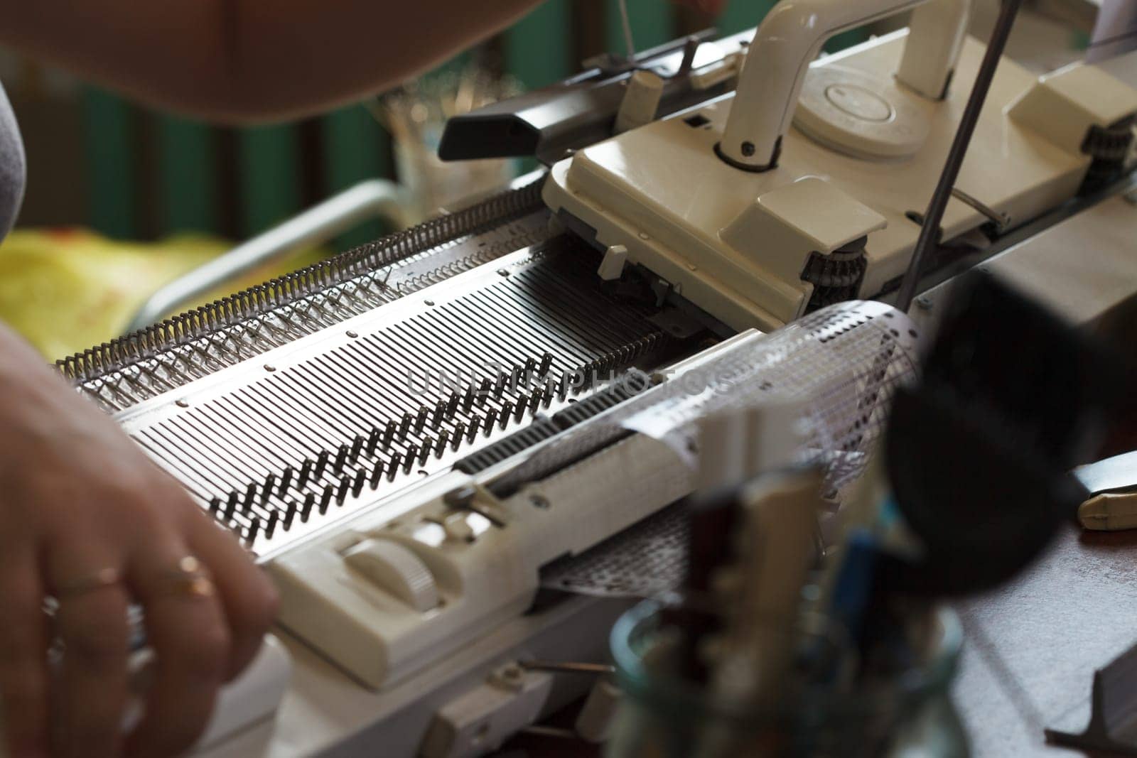 Modern machine for knitting on weaving mill, close-up