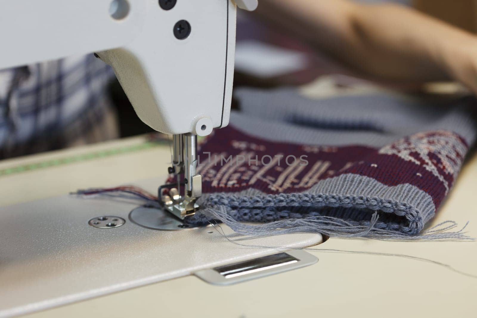 Image of work in sewing shop at textile factory, close-up