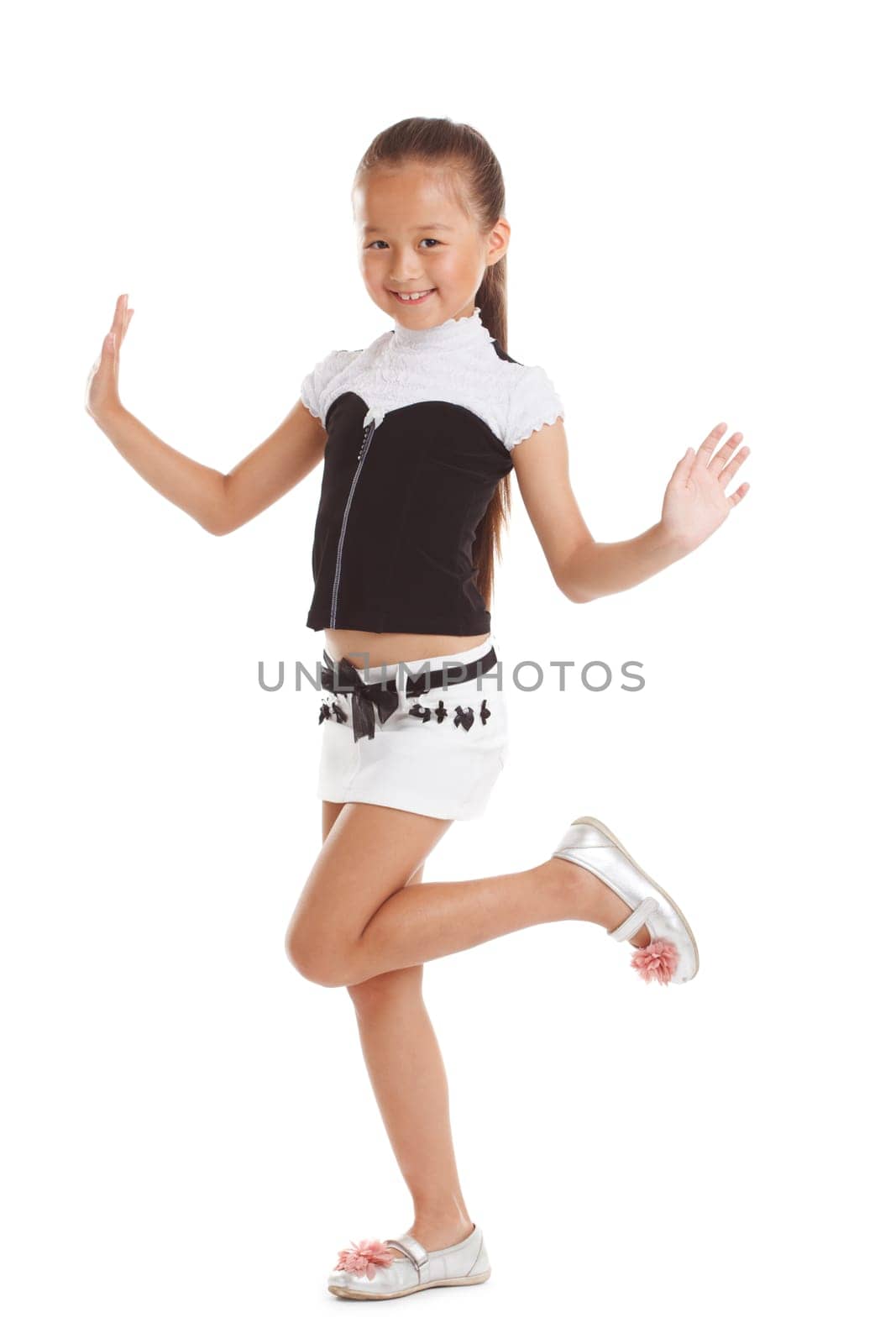 Cheerful little girl posing in fashionable clothes, isolated on white