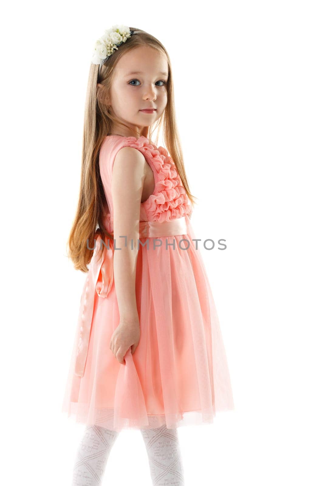 Charming little girl in pink dress and rim of flowers, isolated on white