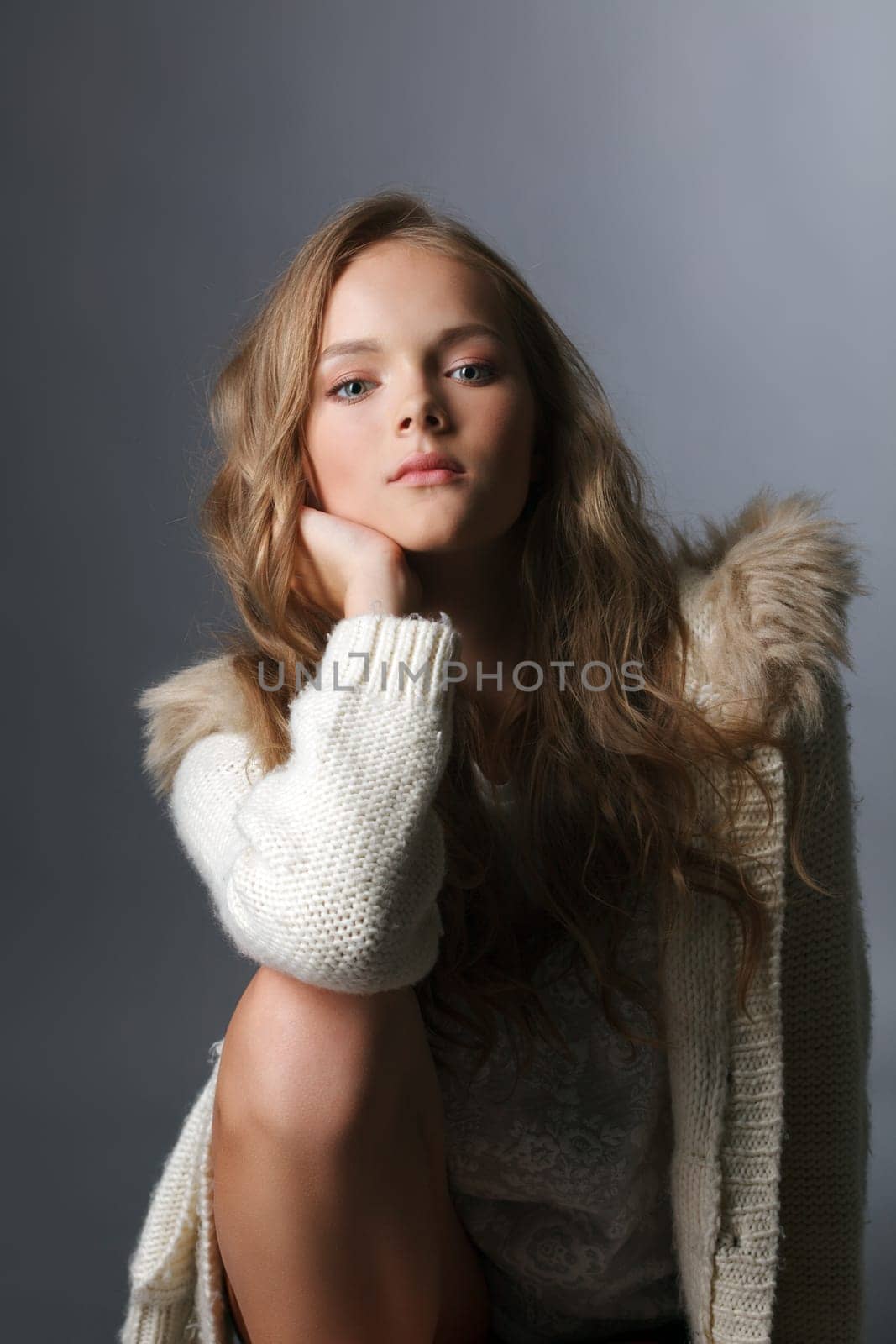 Attractive young model posing in sweater, close-up