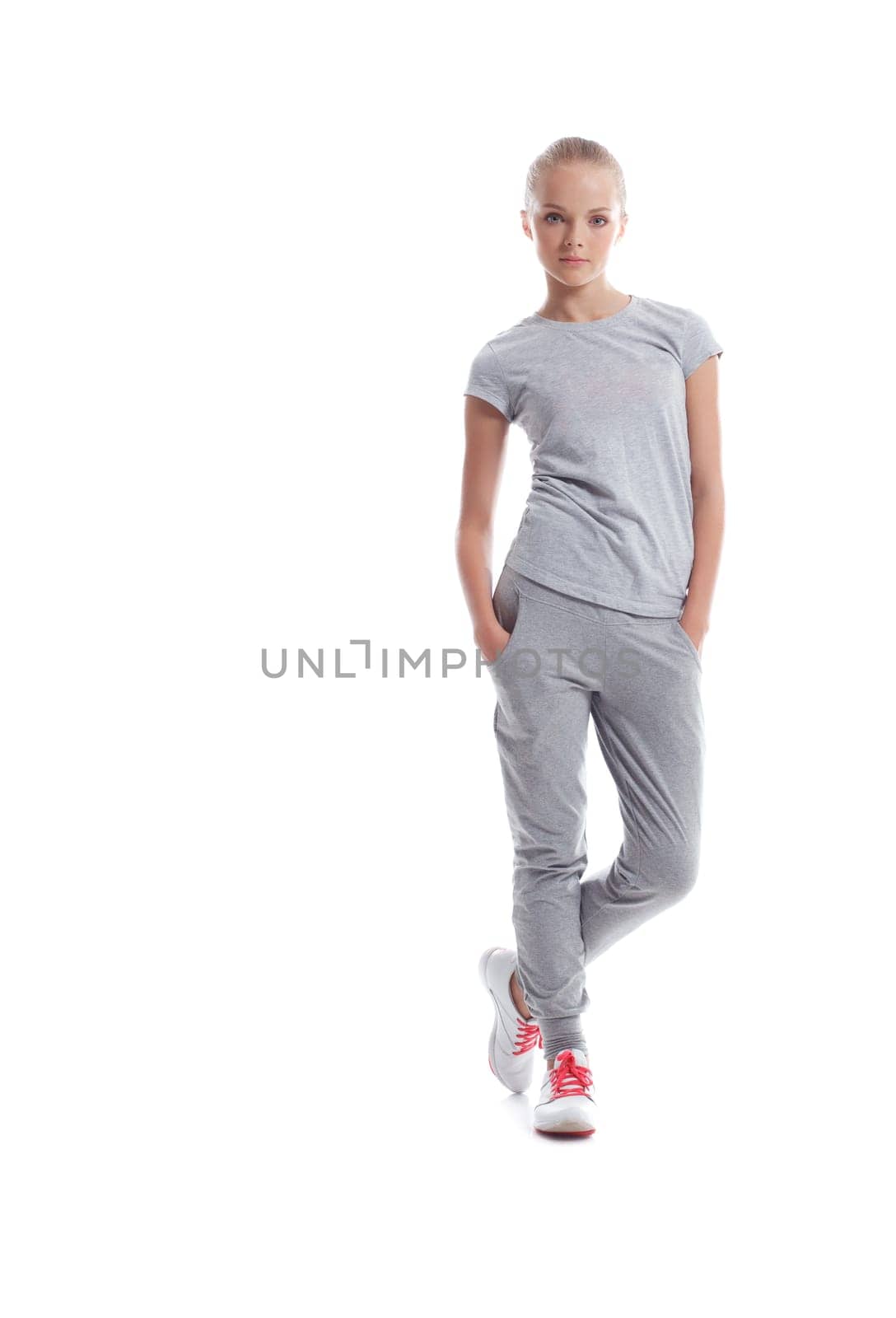 Athletic young woman posing in sportswear, isolated on white background