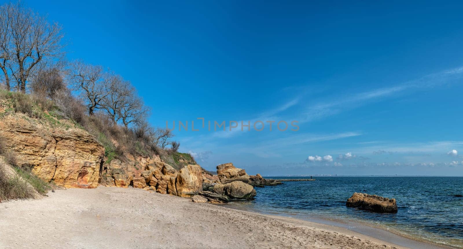 Coast of the Black Sea at the Wild Beach in Odessa, Ukraine, on a sunny spring day