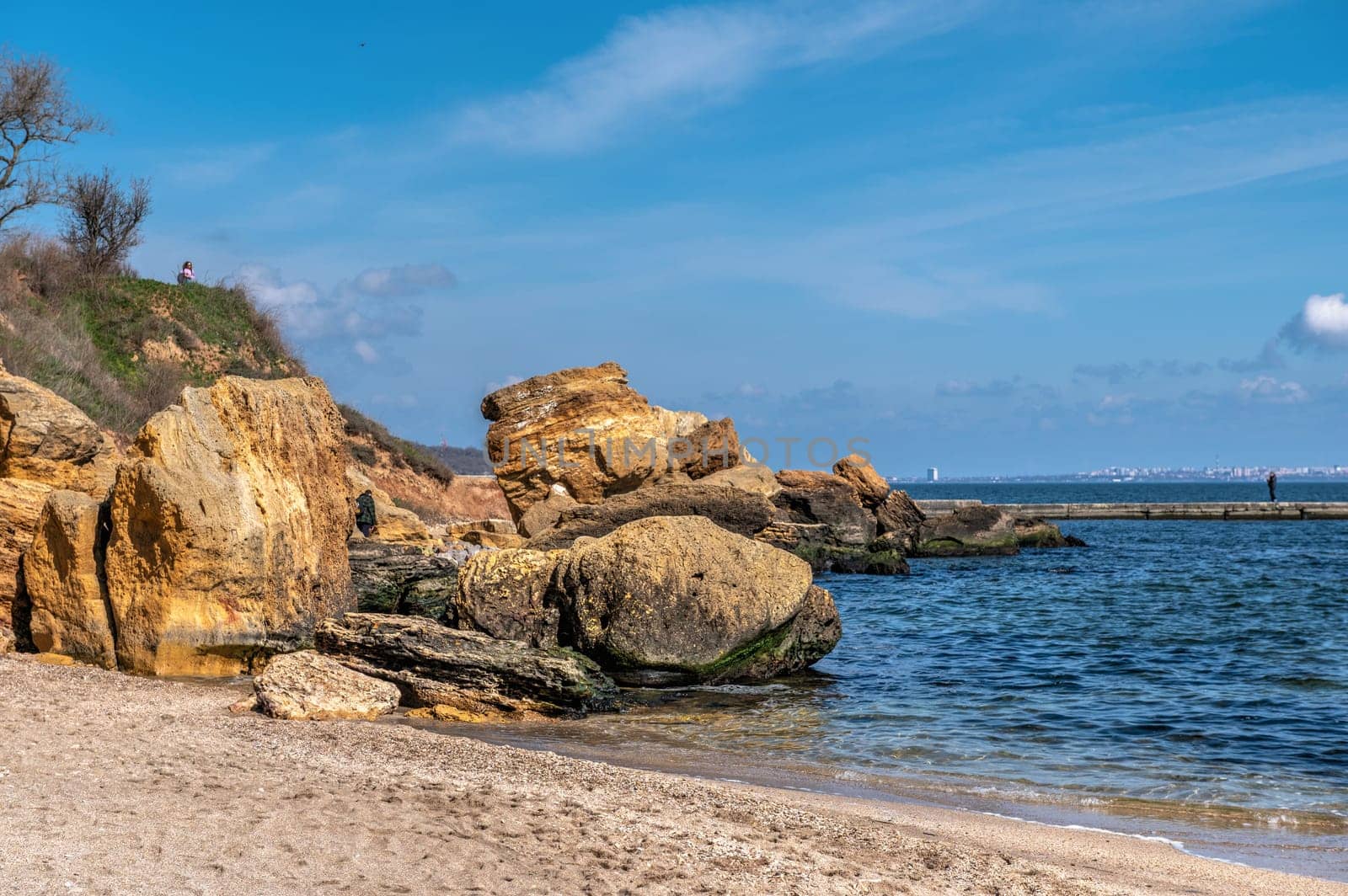 Shell rock boulders on the seashore on the Wild Beach in Odessa, Ukraine, on a sunny spring day