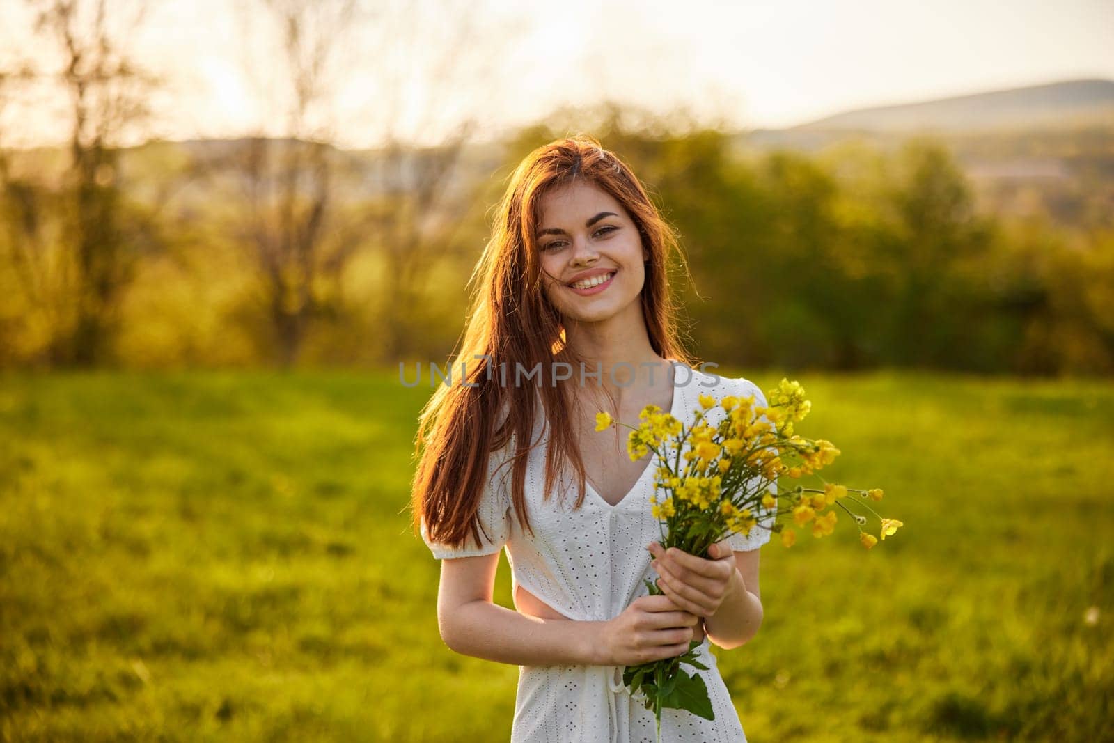 the woman is depicted in the countryside with a bouquet of yellow flowers. High quality photo