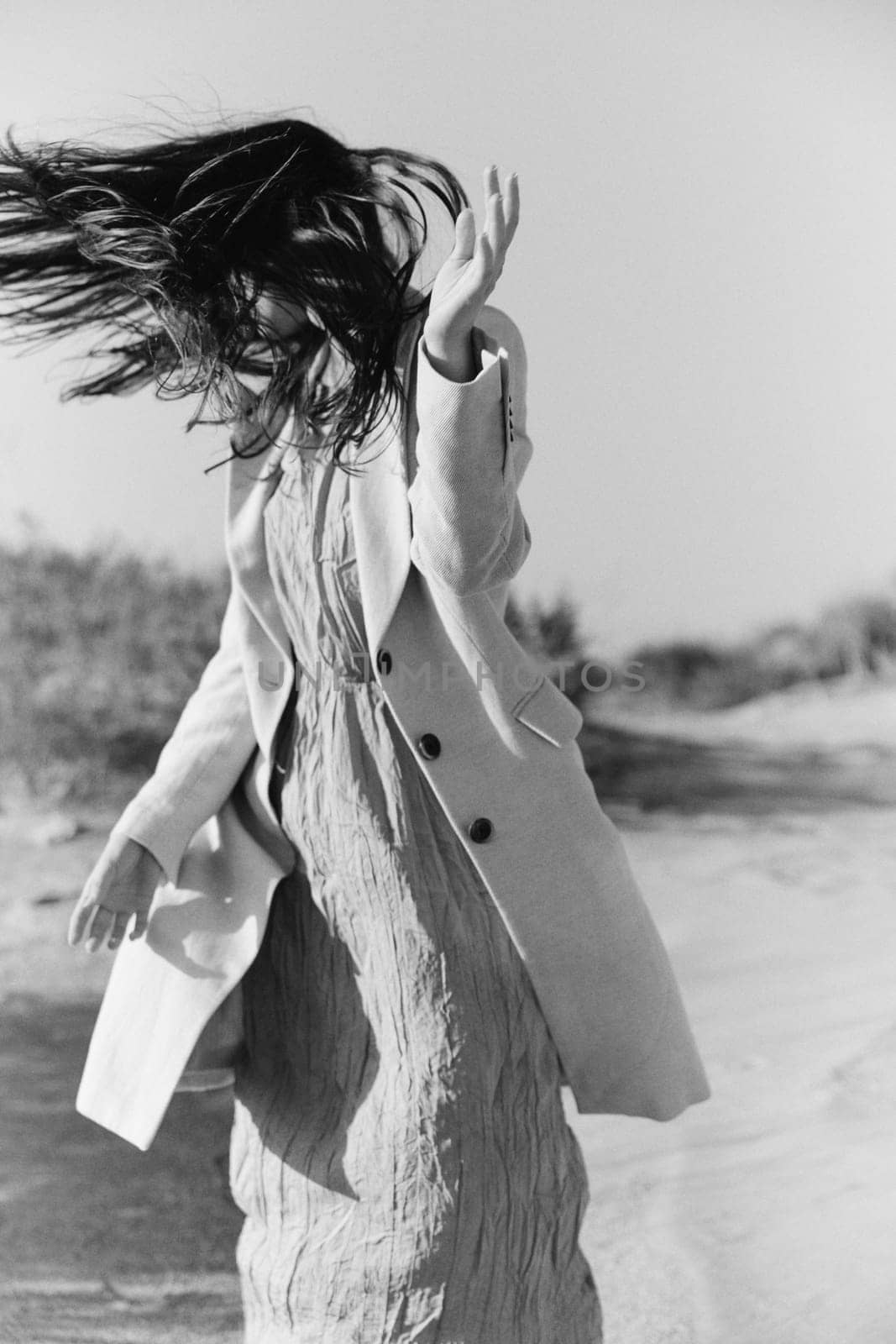 black and white photo of a woman in stylish summer clothes posing in nature. High quality photo