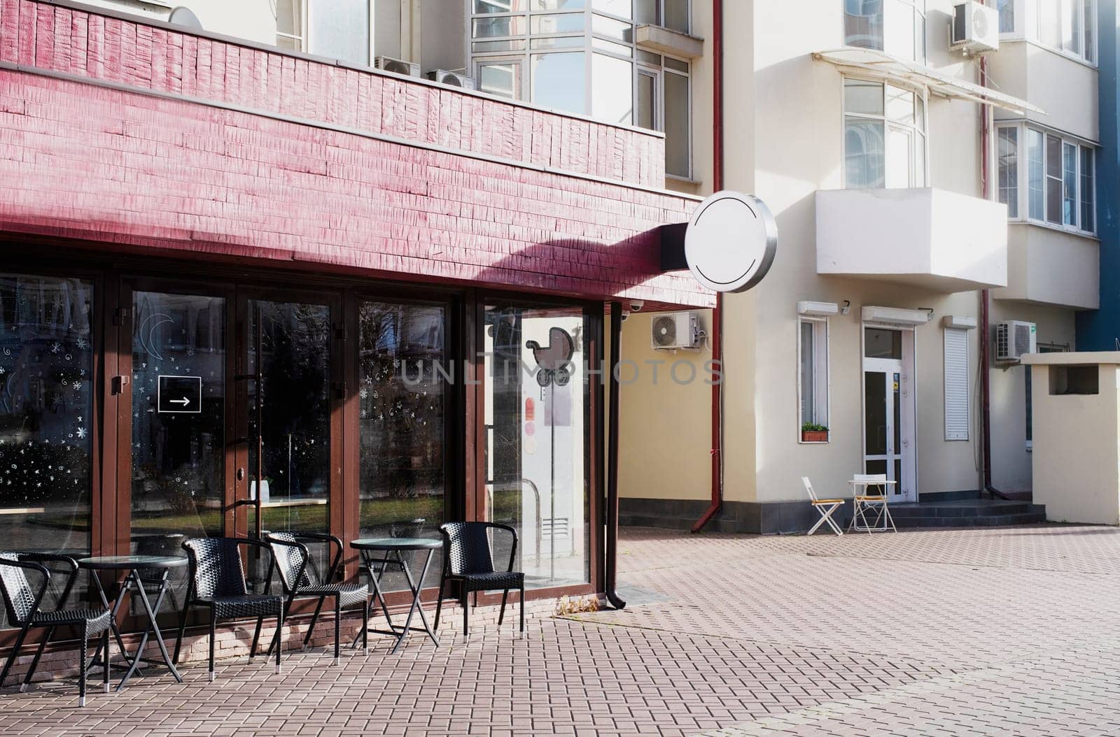 Cafe exterior in the street, white round logo for mockup design