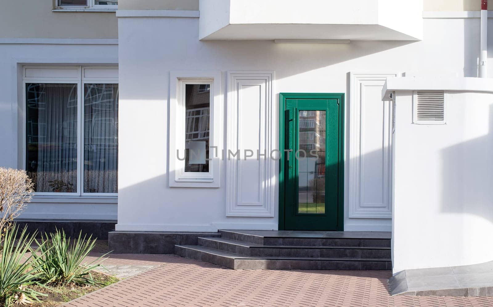 establishment exterior with white walls and green door, mockup design, shadow overlay