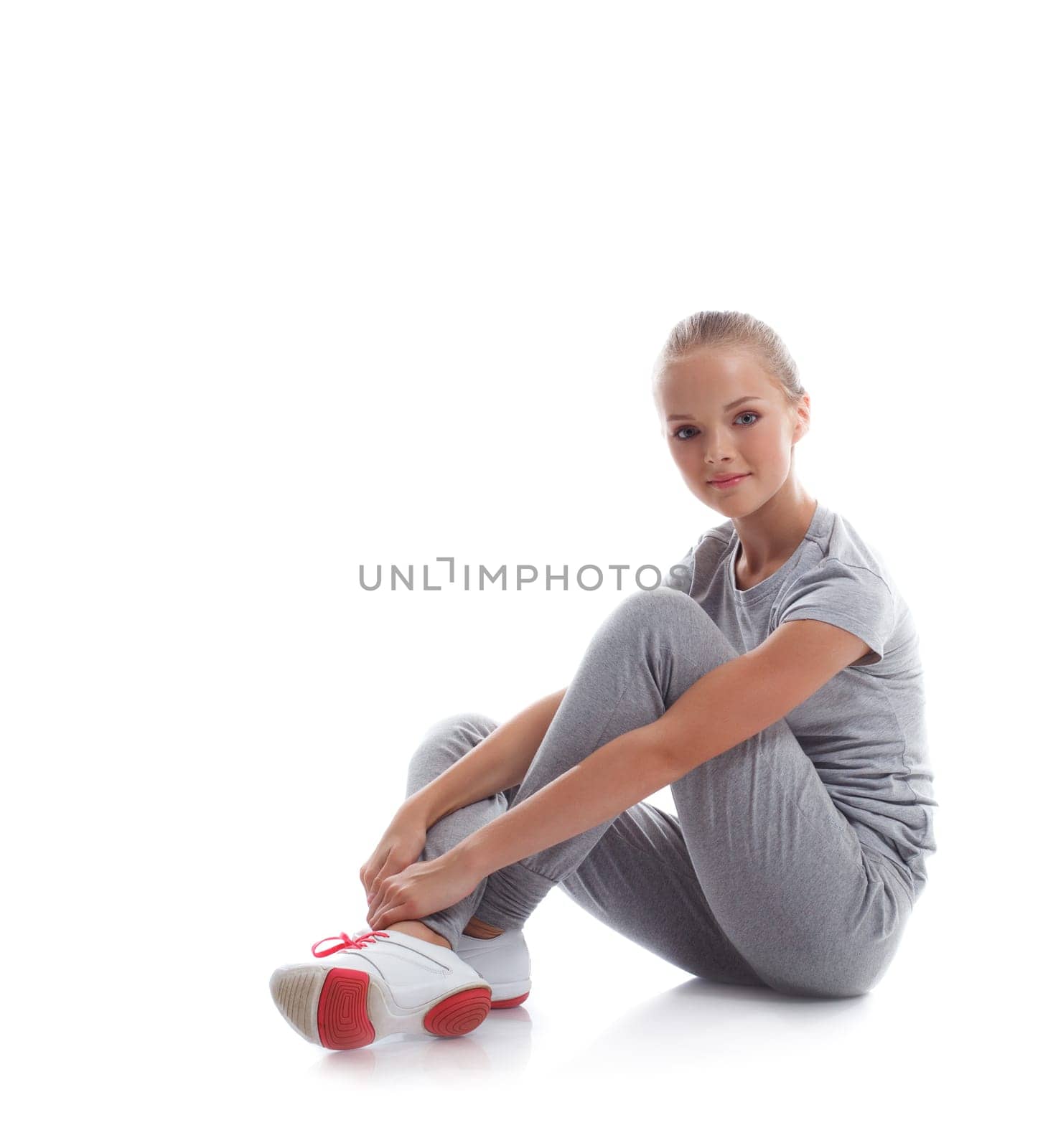 Beautiful young model posing in sportswear, isolated on white
