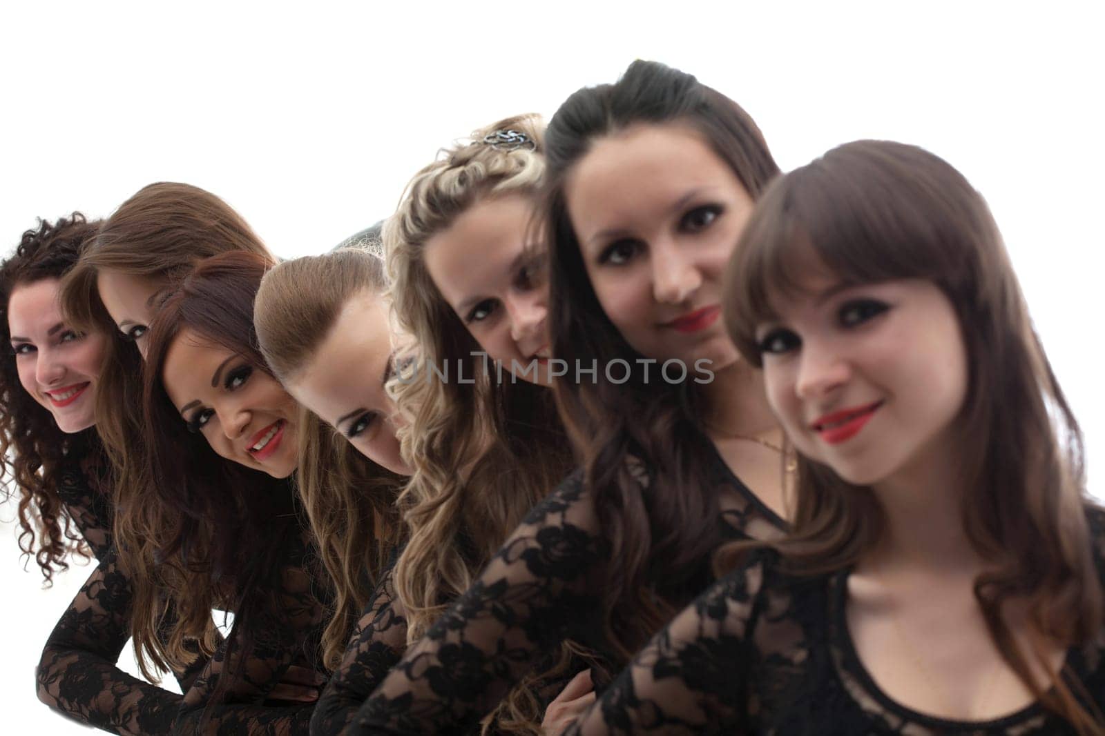 Group of young attractive girls posing in studio, close-up