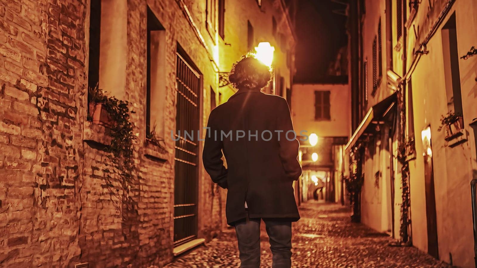 Solitude in the Dark: Young Man Walking Alone in Nighttime City Alleyway by pippocarlot