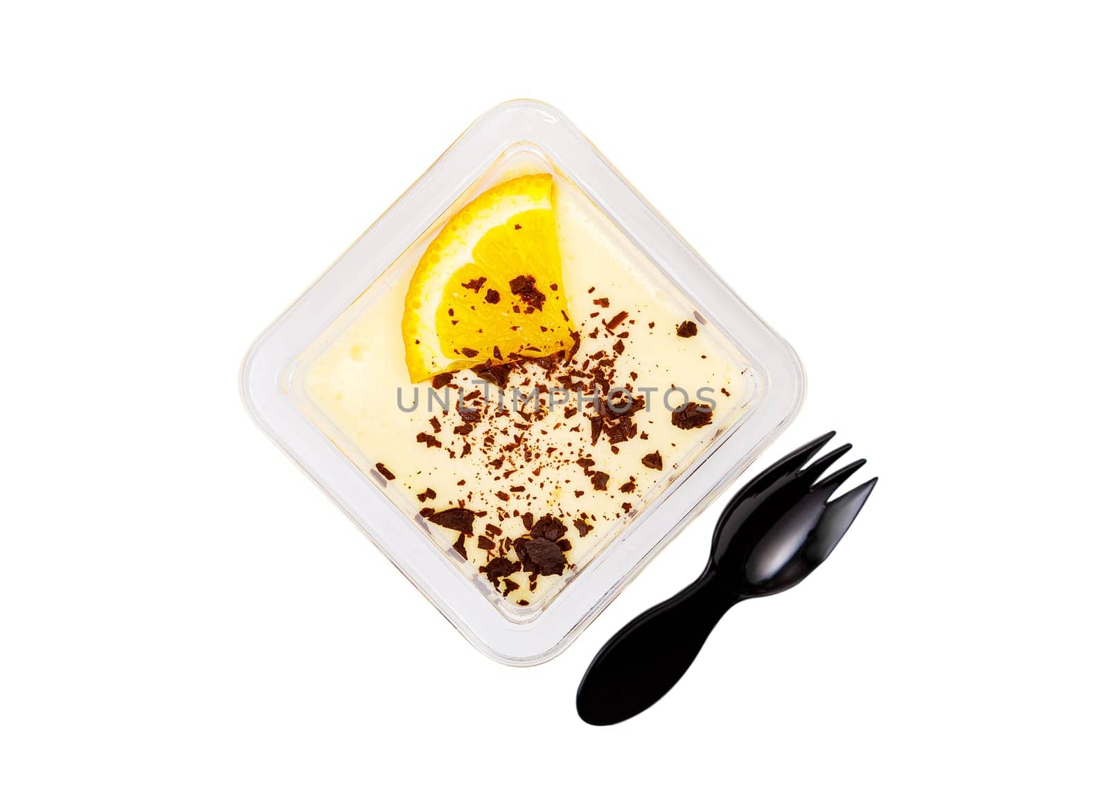 Dessert of white and brown cream with an orange slice in a plastic container on a white background