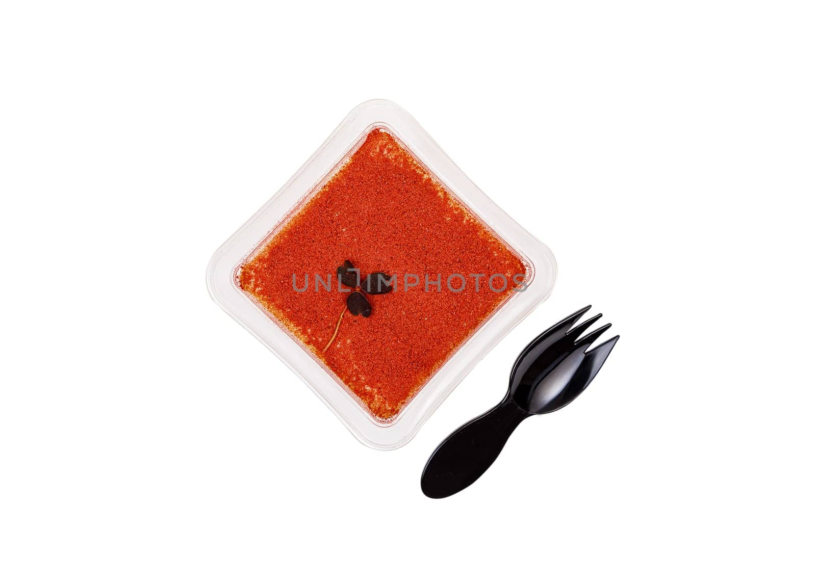 Tiramisu dessert in a plastic box with a fork on a white background. High quality photo
