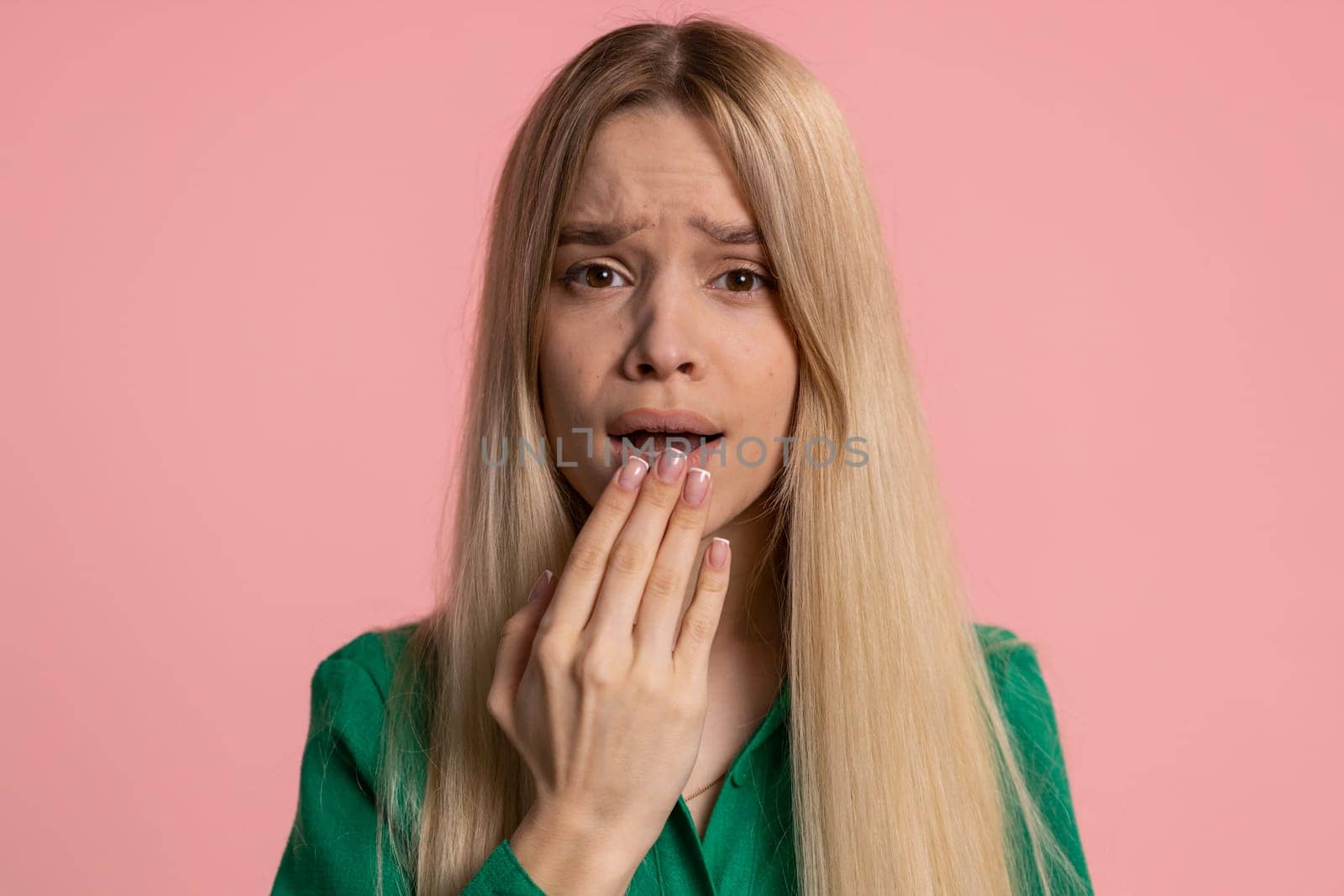 Stressed depressed caucasian woman terrified about danger problems, suffering phobia, anxiety disorder, expresses fear, waving no, insecure, stress panic. Young girl isolated on pink studio background
