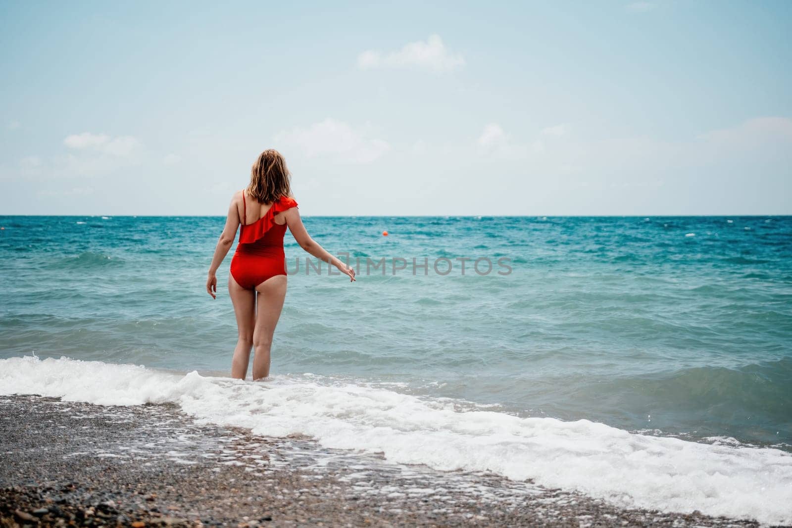 Happy loving family mother and daughter having fun together on the beach. Mum playing with her kid in holiday vacation next to the ocean - Family lifestyle and love concept.