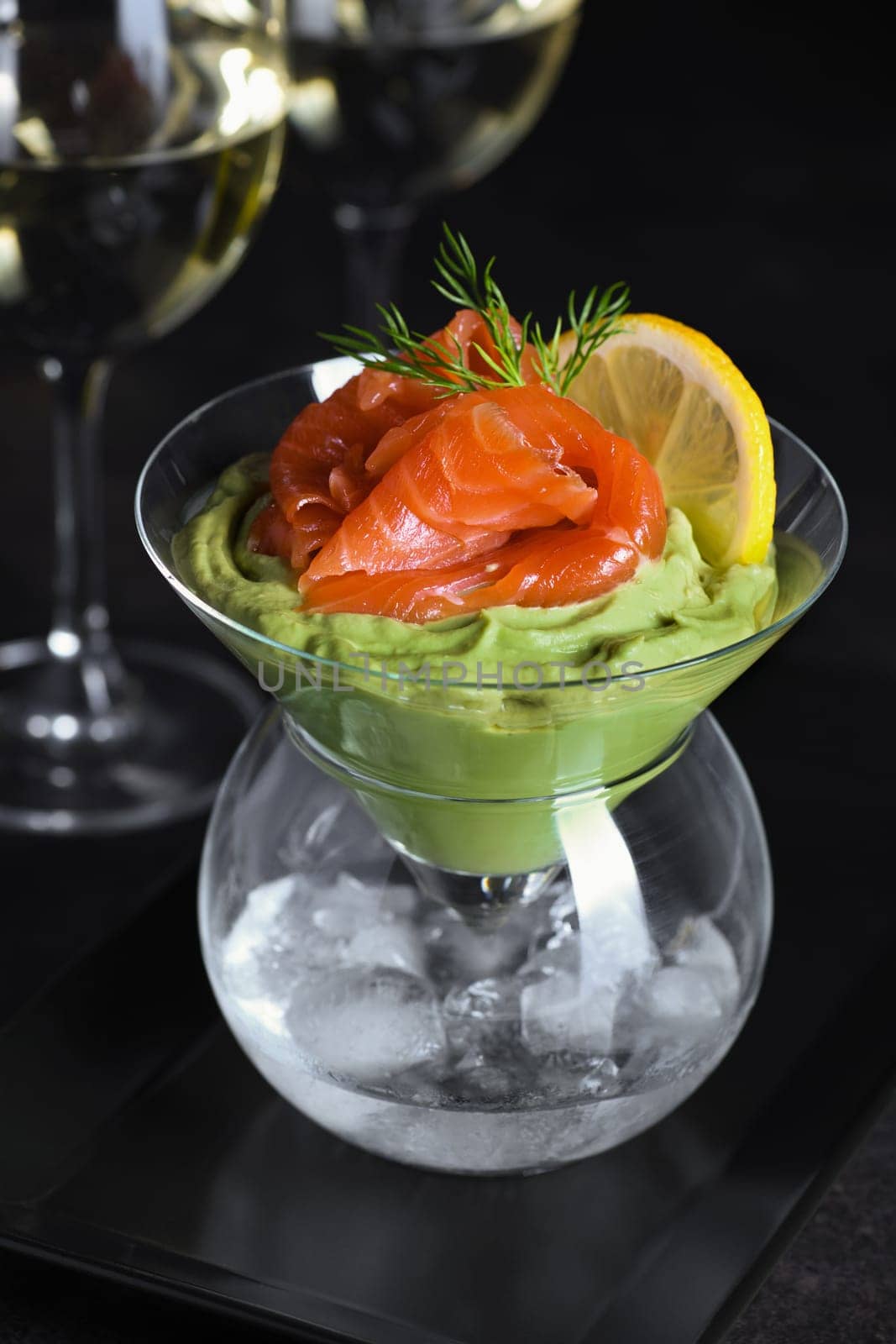 Taste is a combination of avocado pulp with a delicate texture of soft  cheese cream and salmon, with the addition of dill and a slice of lemon. Serving verrine in a Martini Chiller with ice. Aperitif appetizer