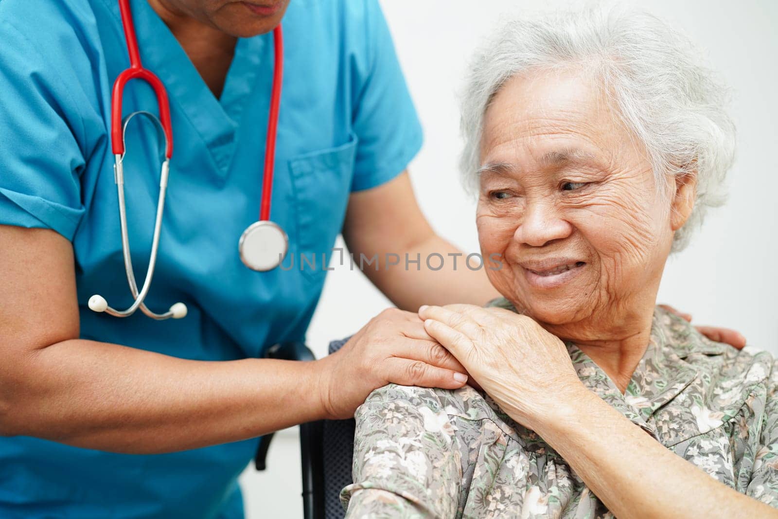 Doctor help Asian elderly woman disability patient sitting on wheelchair in hospital, medical concept.